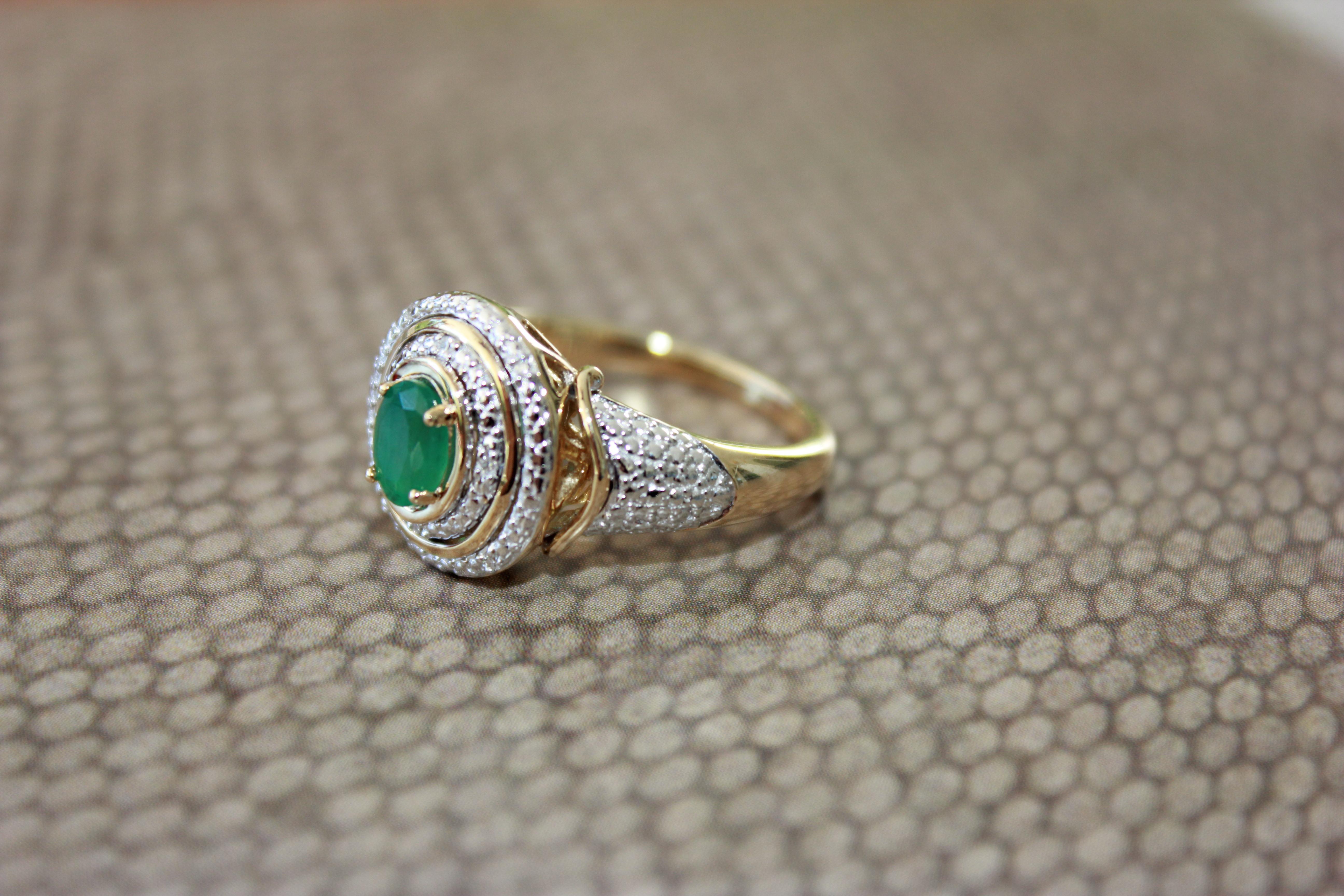 10K Yellow Gold Emerald Ring with diamonds that is perfect as a cocktail ring or an everyday piece. Turn heads with this unique ring with a vintage style.

Diamond weight: 0.03 ct total weight
Emerald size: 6 x 4
Emerald weight: 0.50 ct
