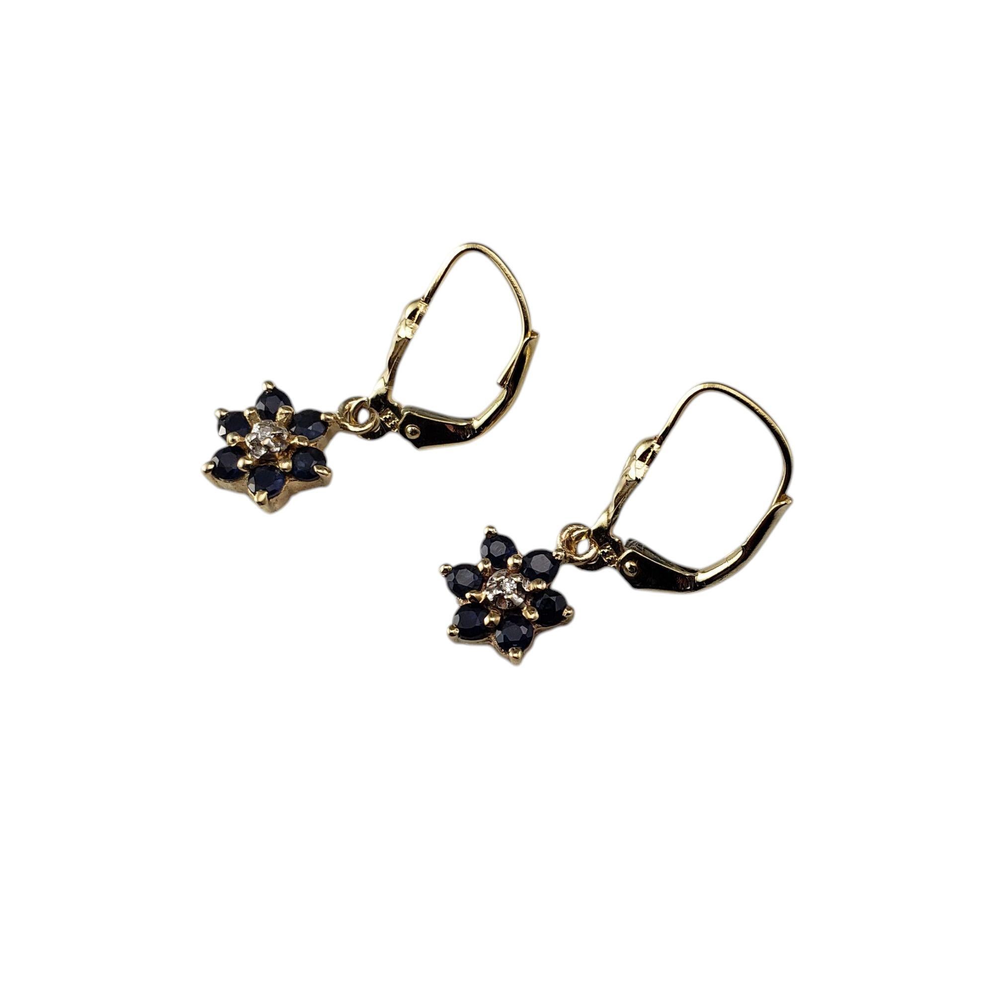 10K Yellow Gold Faceted Blue Stone and Diamond Flower Dangle Earrings-

These elegant dangle earrings each feature six round blue faceted stones and one round single cut diamond set in classic 10K yellow gold.

Approximate total diamond weight: .01