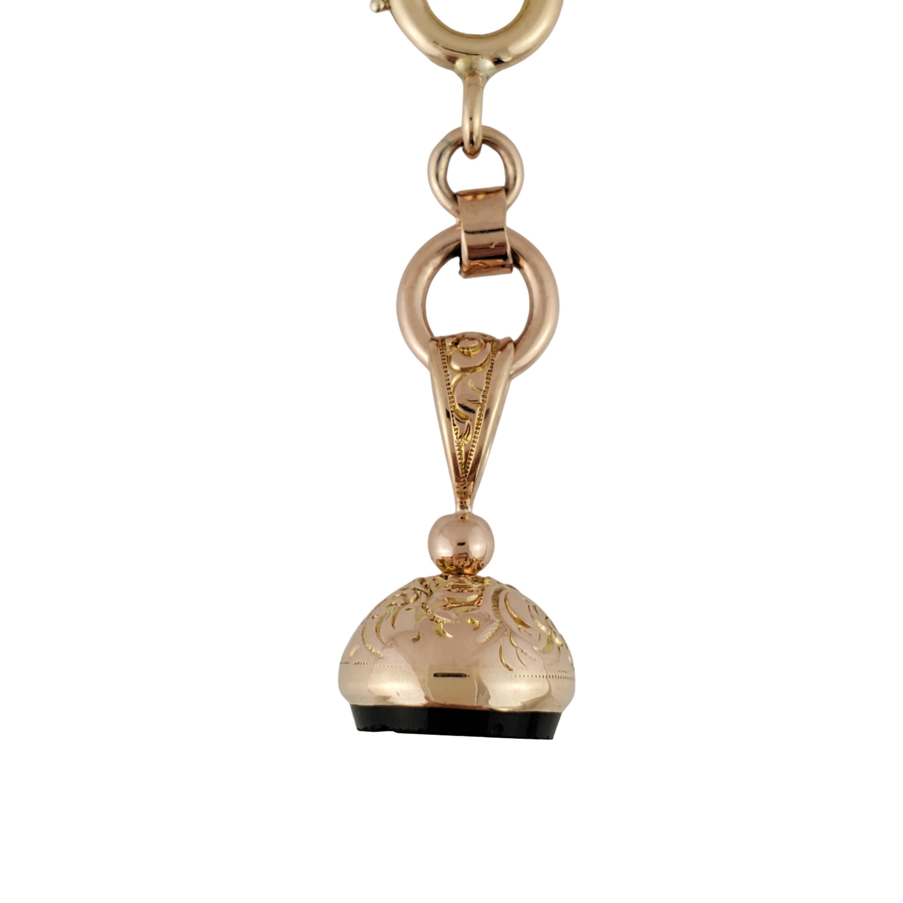 10K Yellow Gold Fob Charm

Beautiful 10K yellow gold fob charm features exquisite line work decorating the entire charm. At the base of the charm is onyx stone with a side profile of a man carved into it, minor chipping around d the edge of the