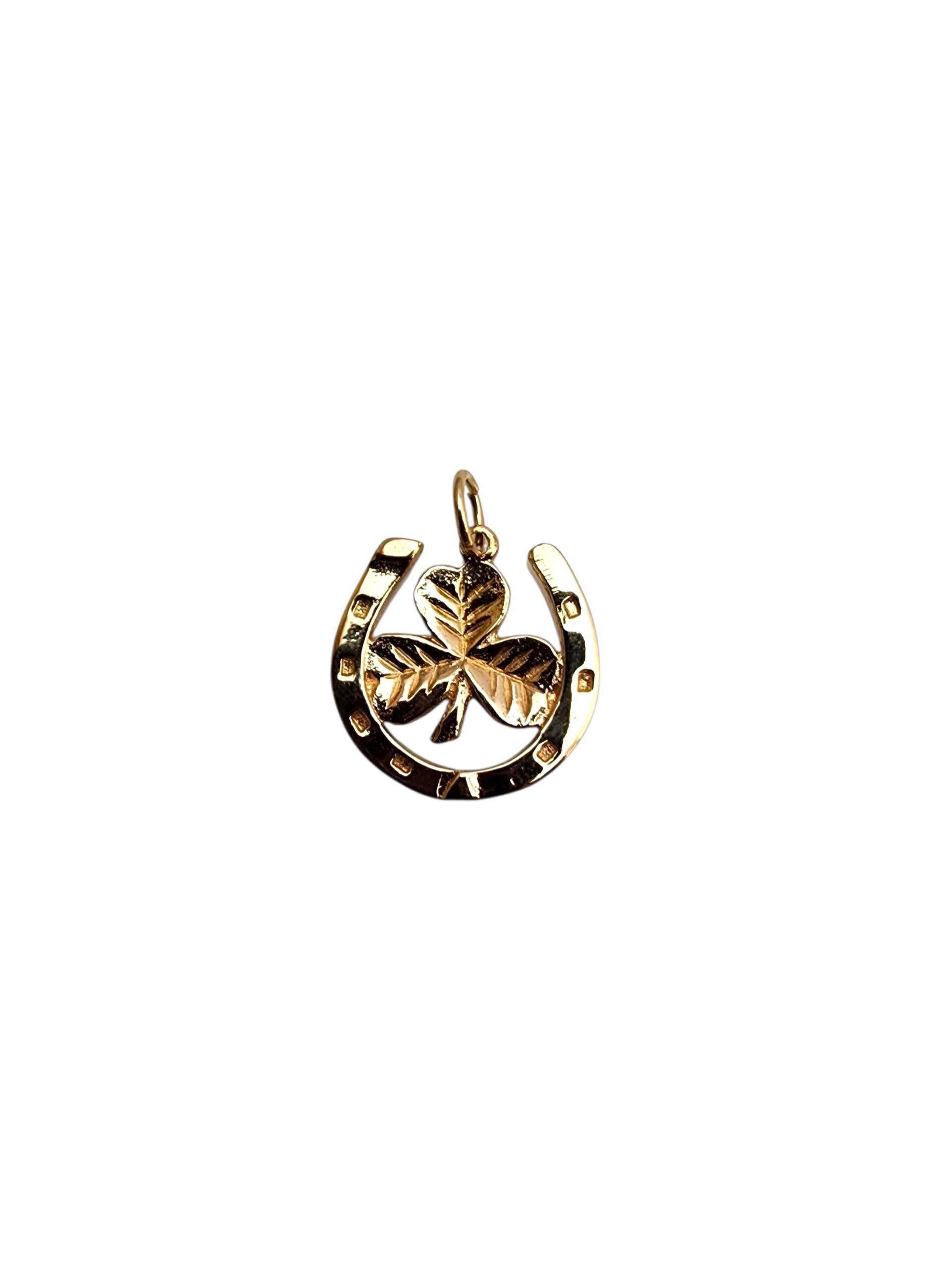 10K Yellow Gold Four Leaf Clover & Horseshoe Pendant -

This 10K yellow gold pendant combines two timeless symbols of luck—the four-leaf clover and the horseshoe—in one charming design. With a bright, polished finish, it’s a stylish and meaningful