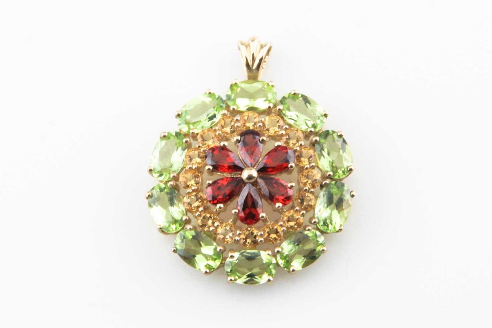 One electronically tested 10KT yellow gold ladies cast multi-gemstone pendant with a bright polish finish.
Condition is good.
Ladies 10KT Yellow Gold Multi-Gemstone Floral Design Pendant
The pendant features garnets in a stylized floral pattern set