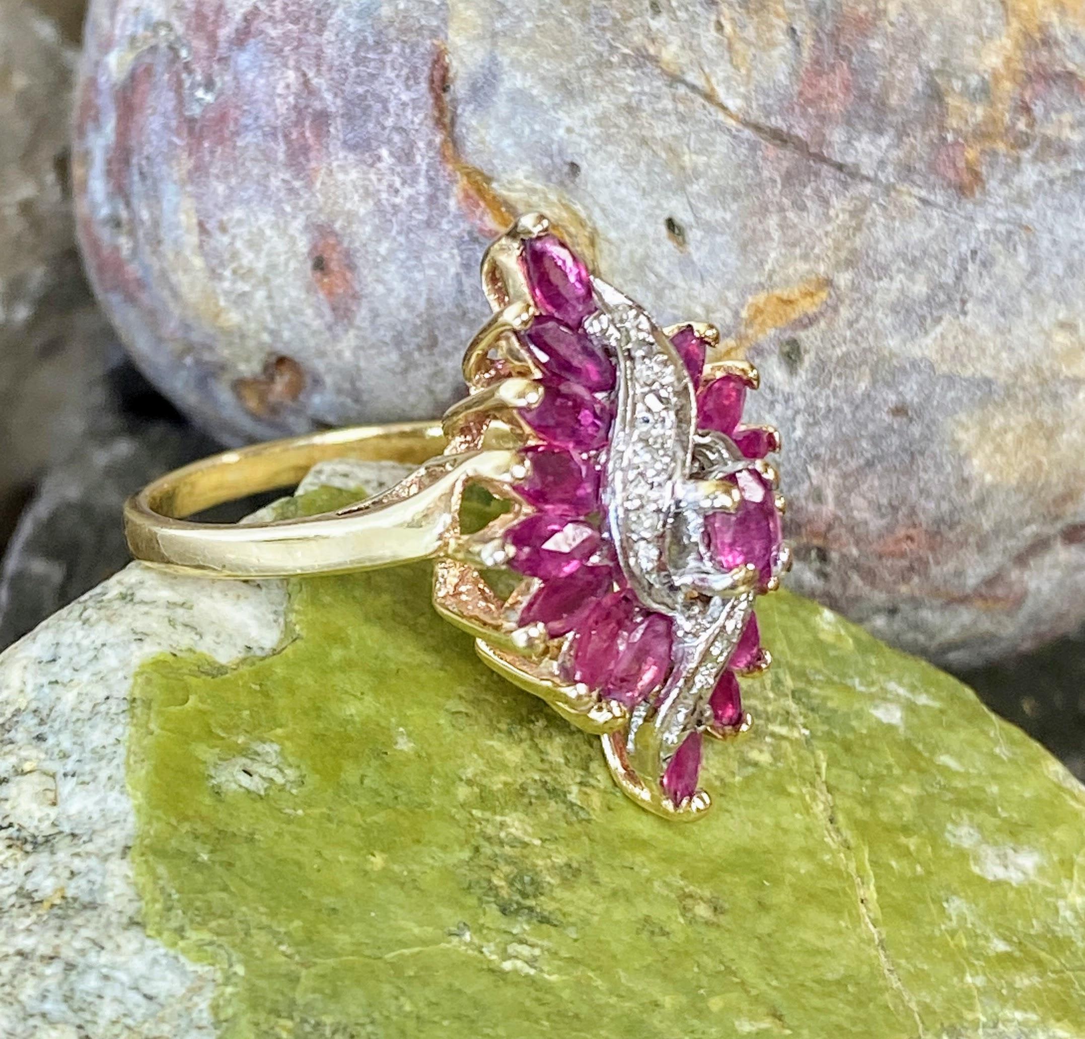 This is a gorgeous marquise ruby and diamond waterfall ballerina Ring. The a ring is centered with an oval faceted ruby. The ring cascades down with an undulating halo of 16 marquise cut rubies. The rubies are highlighted by ribbons of diamonds set