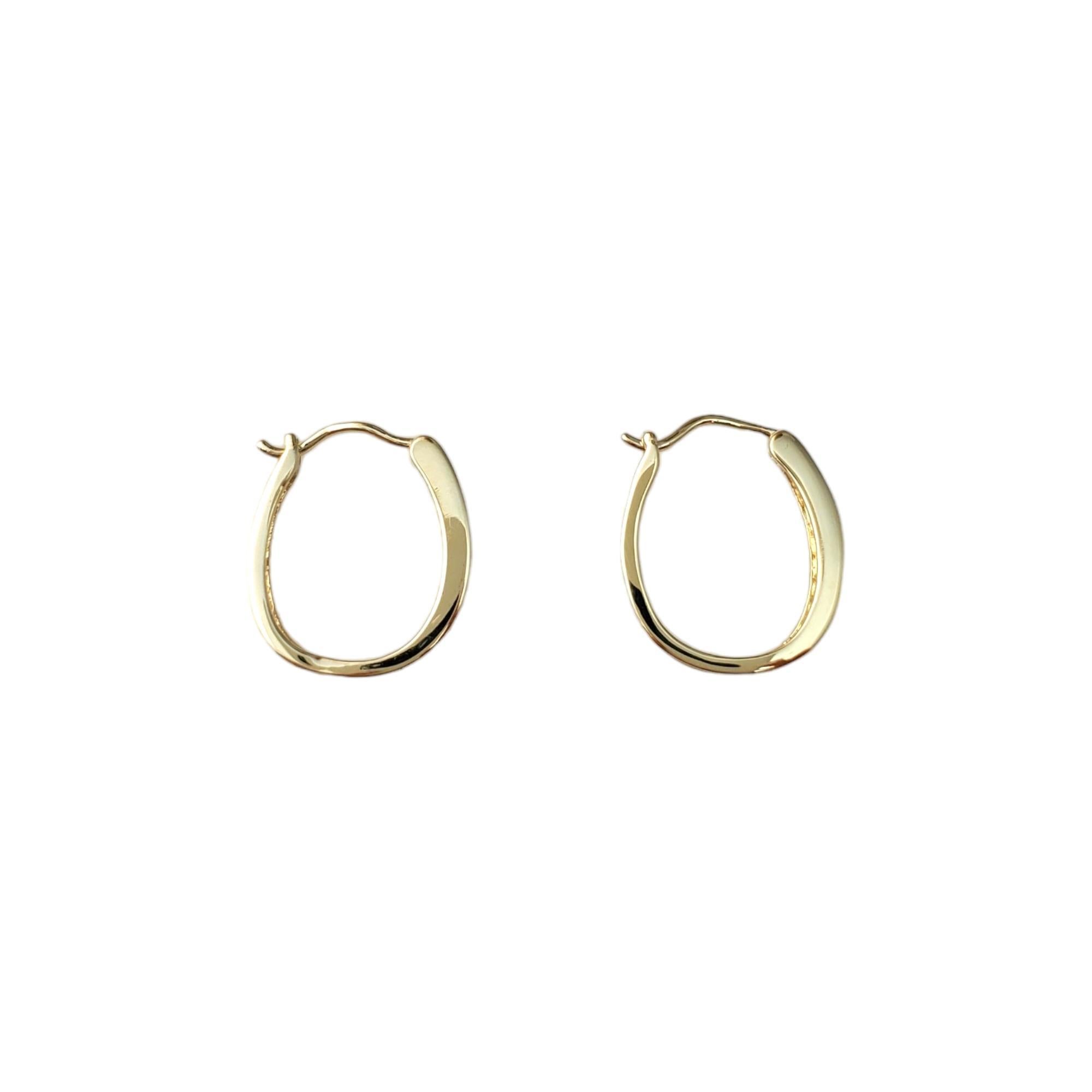 10K Yellow Gold Diamond Hoop Earrings -

These sparkling earrings feature 16 round brilliant diamonds. 

Approximate total diamond weight:  .24cts.

Diamond color:  I

Diamond clarity:  I2-I3

Size:  19.2 mm x 3.2 mm X 16.1 mm 

Weight:  1.6 dwt./ 