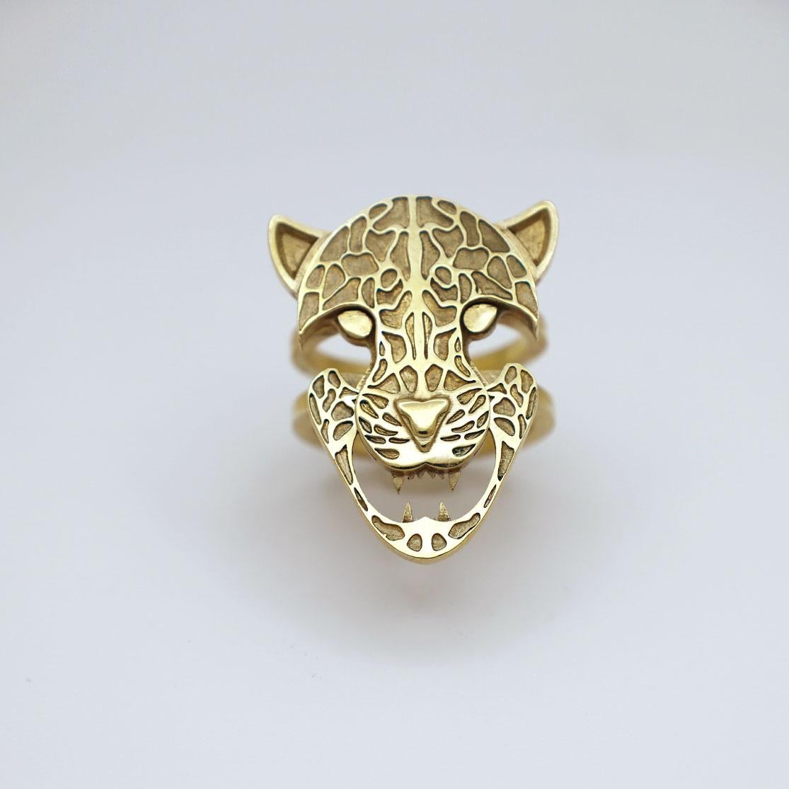 This contemporary ring reinterprets the stackable ring. Made of 10K yellow gold, the piece consists of two individual rings, which interlock to form the face of a panther. When slid apart, the panther bares its teeth, its expression changing from