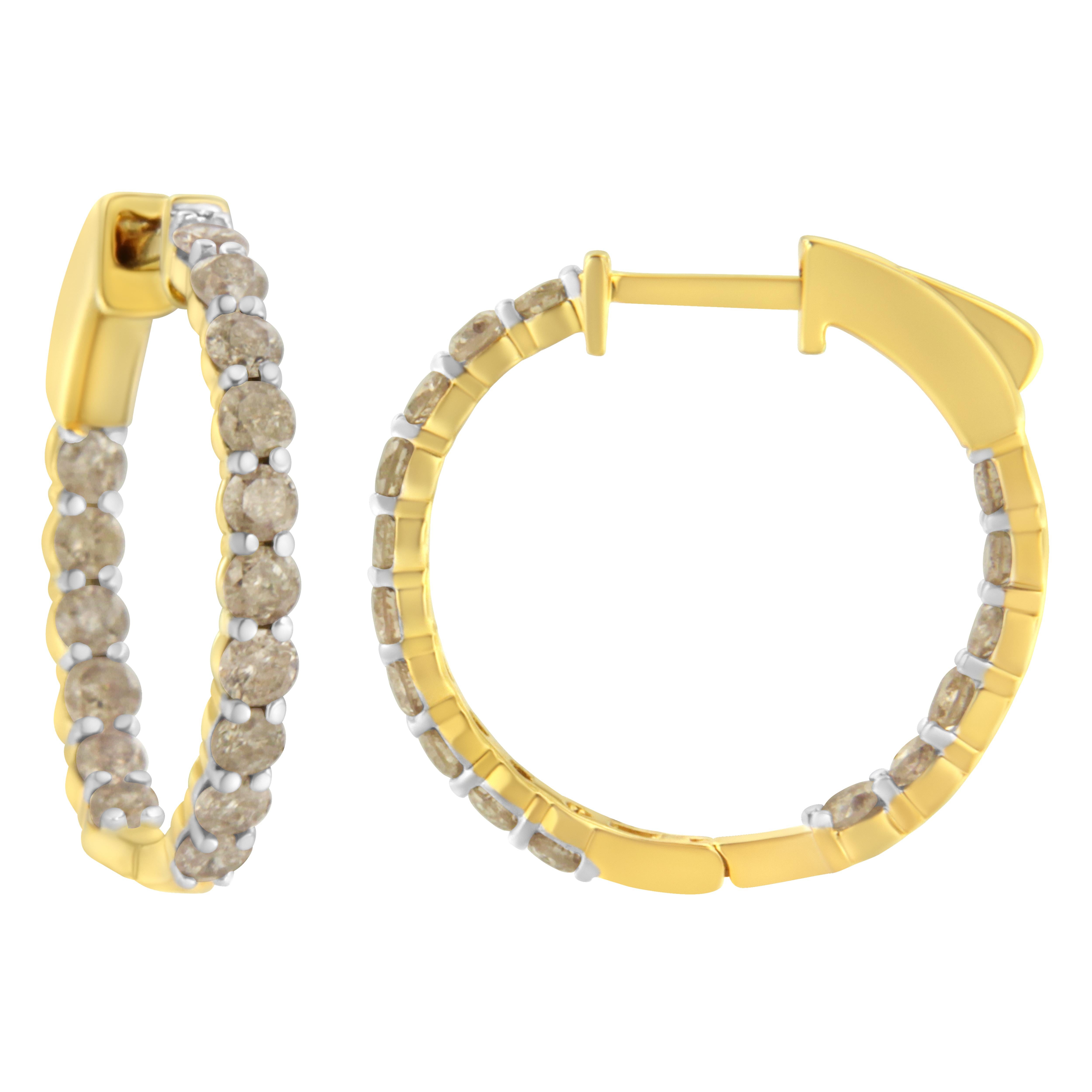 Trendy and chic diamond hoop earrings that are the perfect addition to any jewelry collection. Created in the finest 10k yellow gold plated sterling silver, this fabulous piece has round-cut diamonds on the outer and inner part of the earring. With