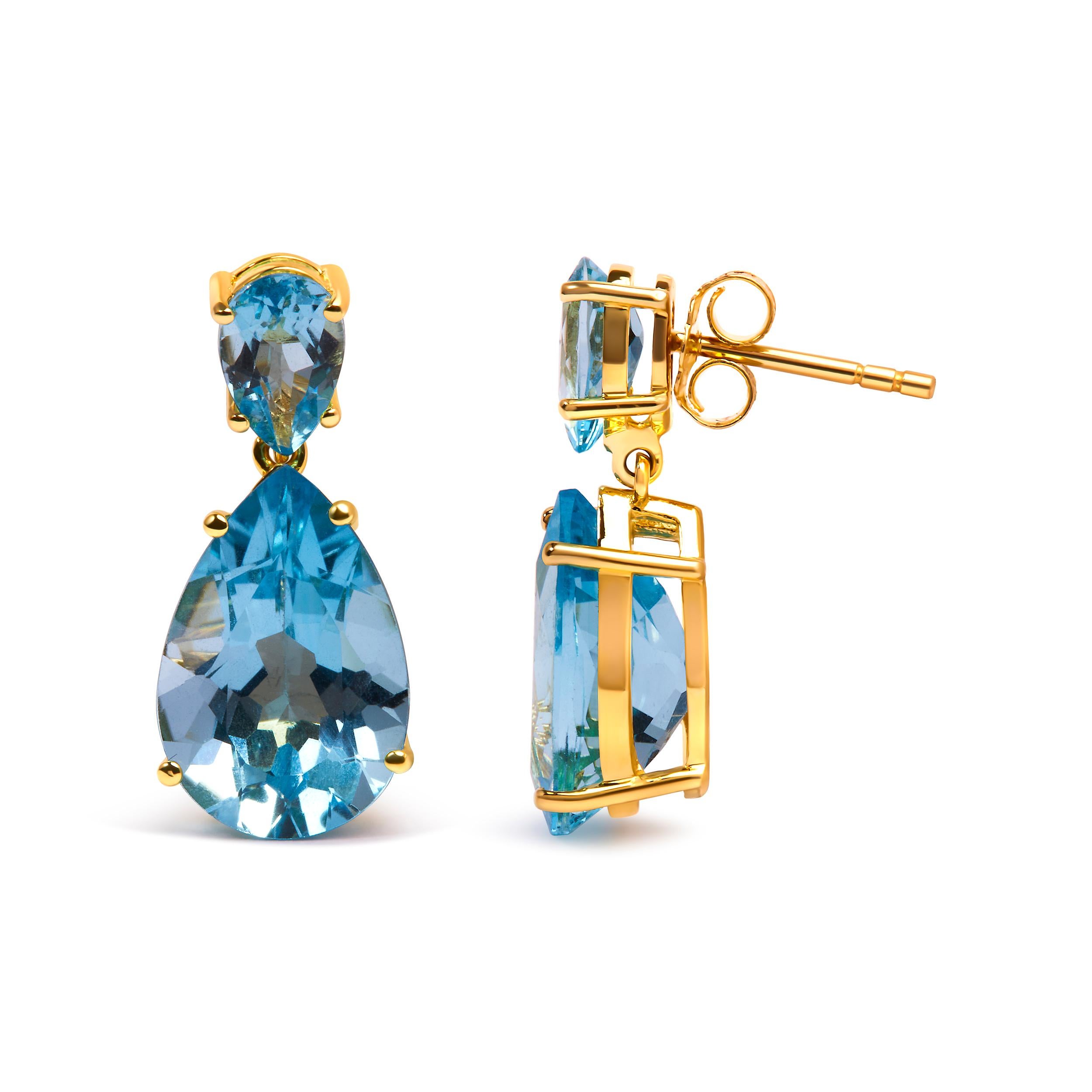 Indulge in the ethereal beauty of these exquisite earrings, crafted with utmost precision and adorned with captivating blue topaz gemstones. Made from 10K yellow gold plated .925 sterling silver, these dangle earrings showcase a mesmerizing