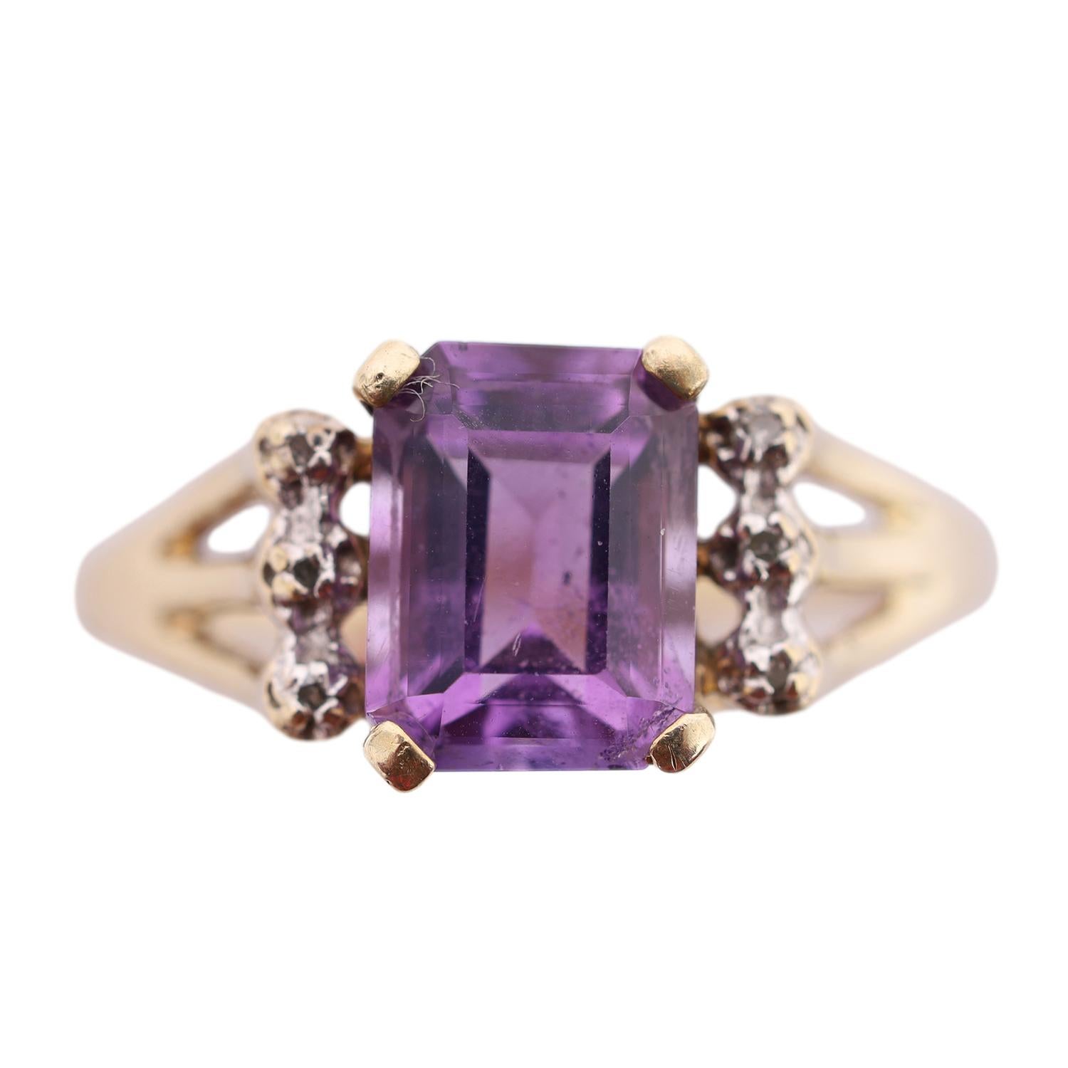 Curated by The Lady Bag Ladies 

Being offered for sale is a 10K Yellow Gold Emerald Cut Amethyst and Diamond Ring

The ring features an emerald cut middle stone prong set amethyst. It measures in at 7.94mm in length and 6.08mm in width. Directly on