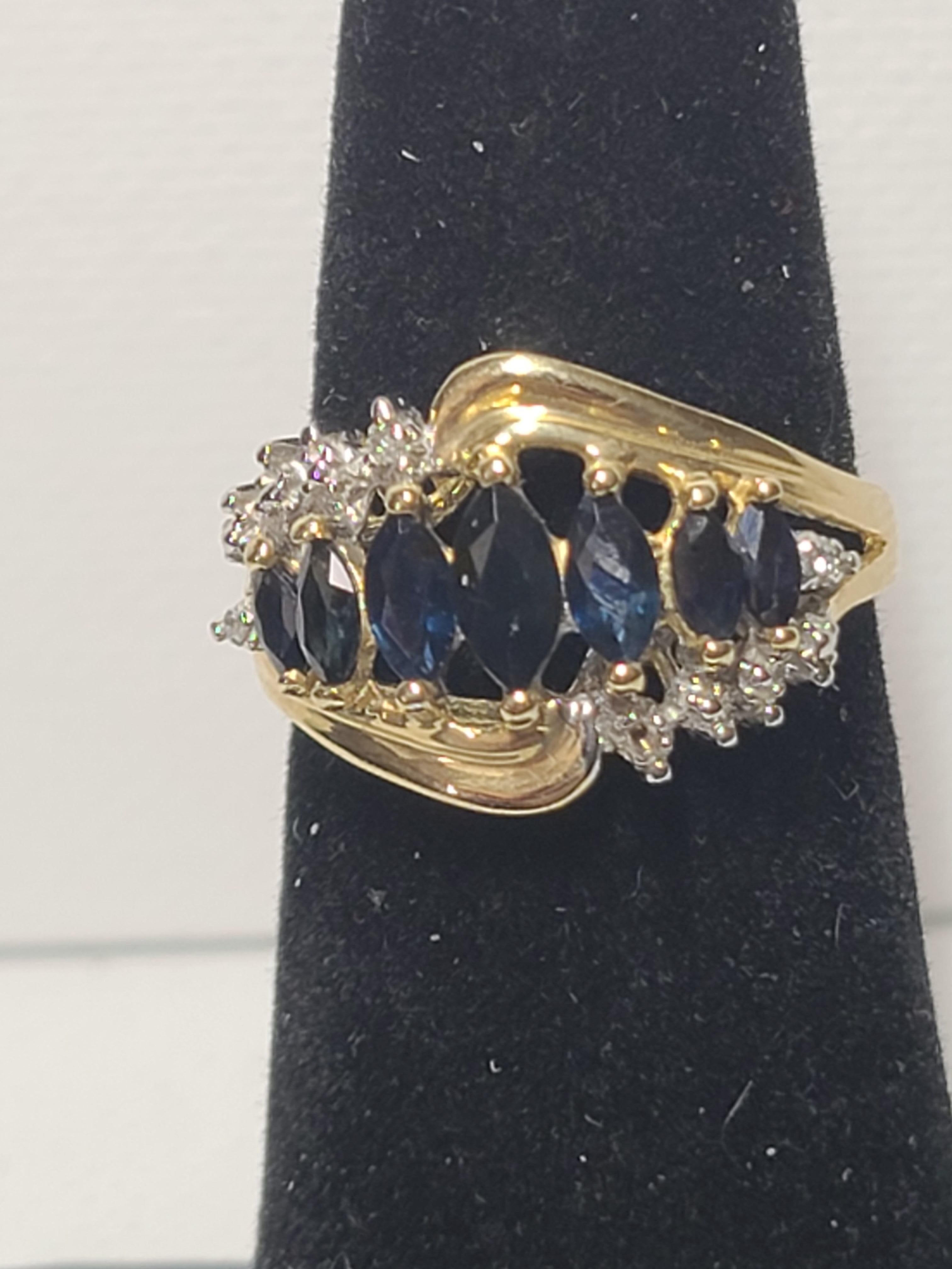 This estate found ring features seven marquise cut sapphires and ten small round cut diamonds in a 10K yellow gold setting. The sapphires test as lab created stones, the diamonds test as real.
This beautiful cocktail ring is size 6.75 (US) and