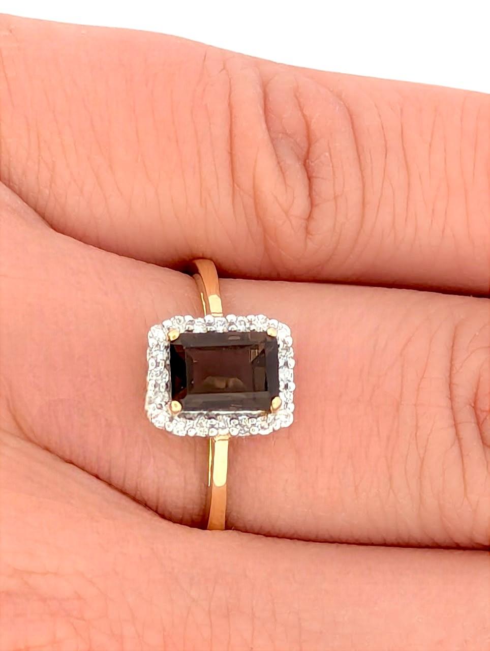 Earthy elegance meets golden warmth in this 10k yellow gold smoky quartz and diamond halo ring from Mountain Song Jewelers. Featuring a captivating .85 CT oval smoky quartz at the center, this ring is accented with a sparkling halo of .15 CTW