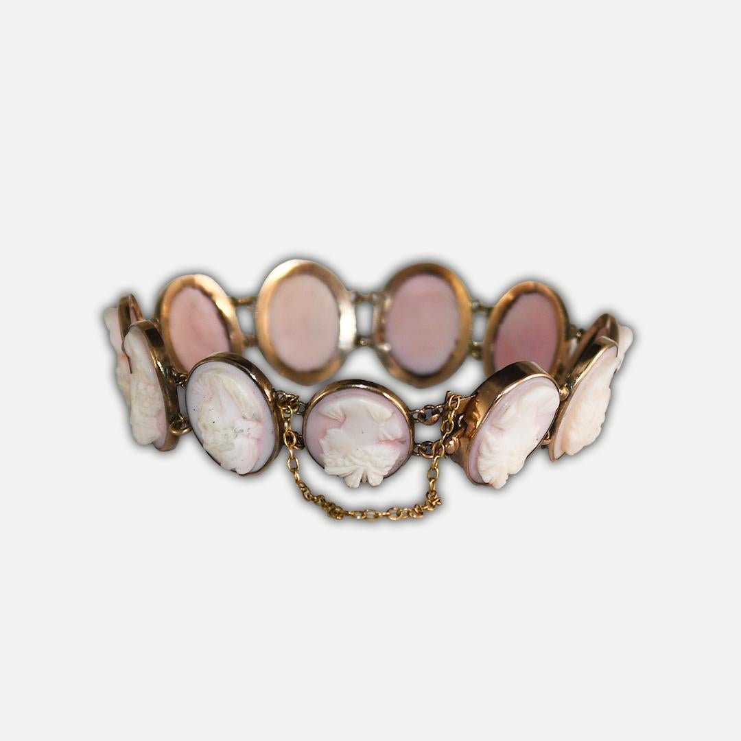 Vintage 10k yellow gold and shell cameo bracelet.
Tests 10k and weighs 13 grams gross weight.
The cameos are hand carved from giant conch shells.
They measure 15.5mm long.
There are two 10k gold California gold tokens attached to the safety