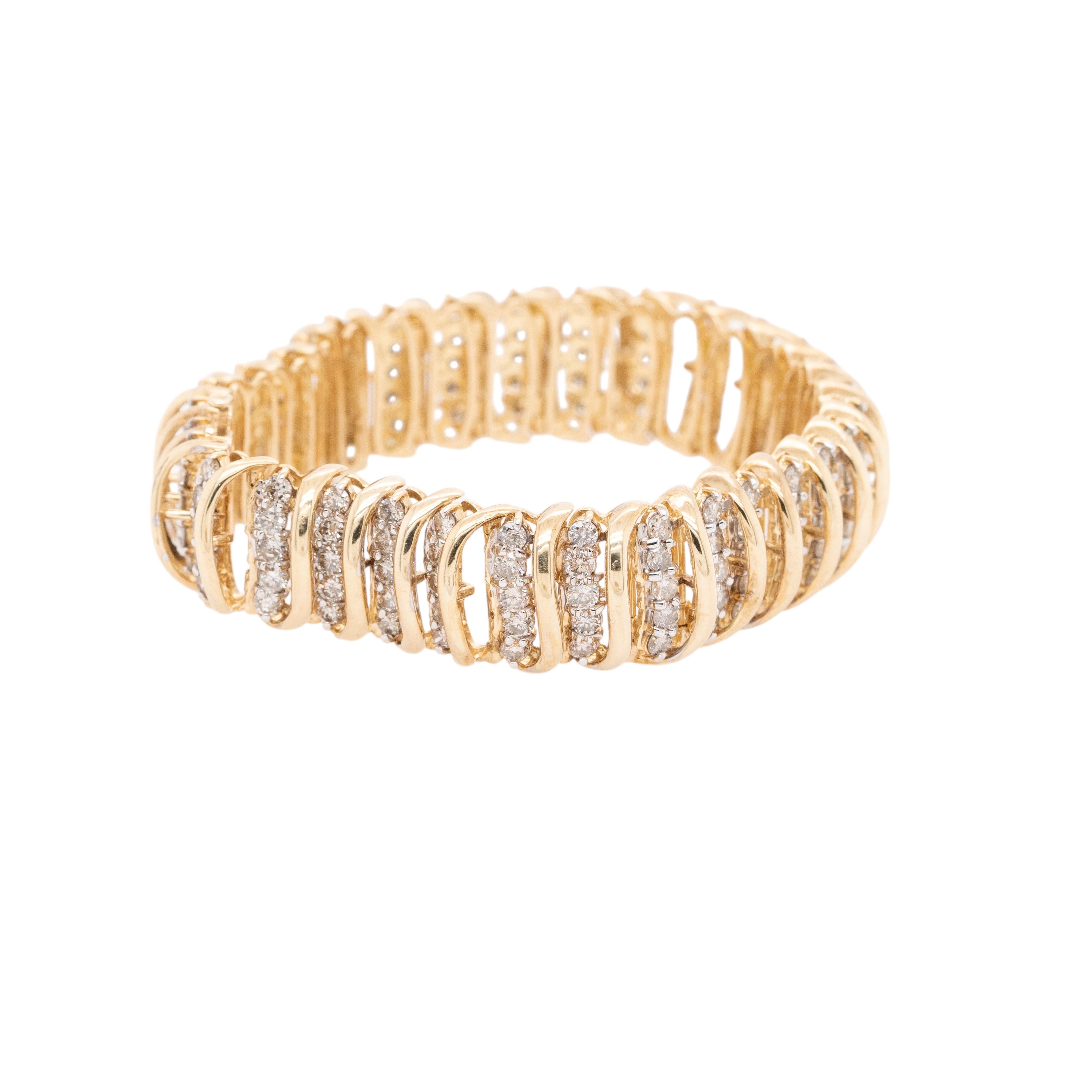 This 10k Yellow Gold Vintage Snake Bracelet features approximately 3.2ctw of diamonds set in an intricately designed snake motif. Weighing 39g (25dwt), this bold and unique bracelet showcases a vintage aesthetic with a striking 7