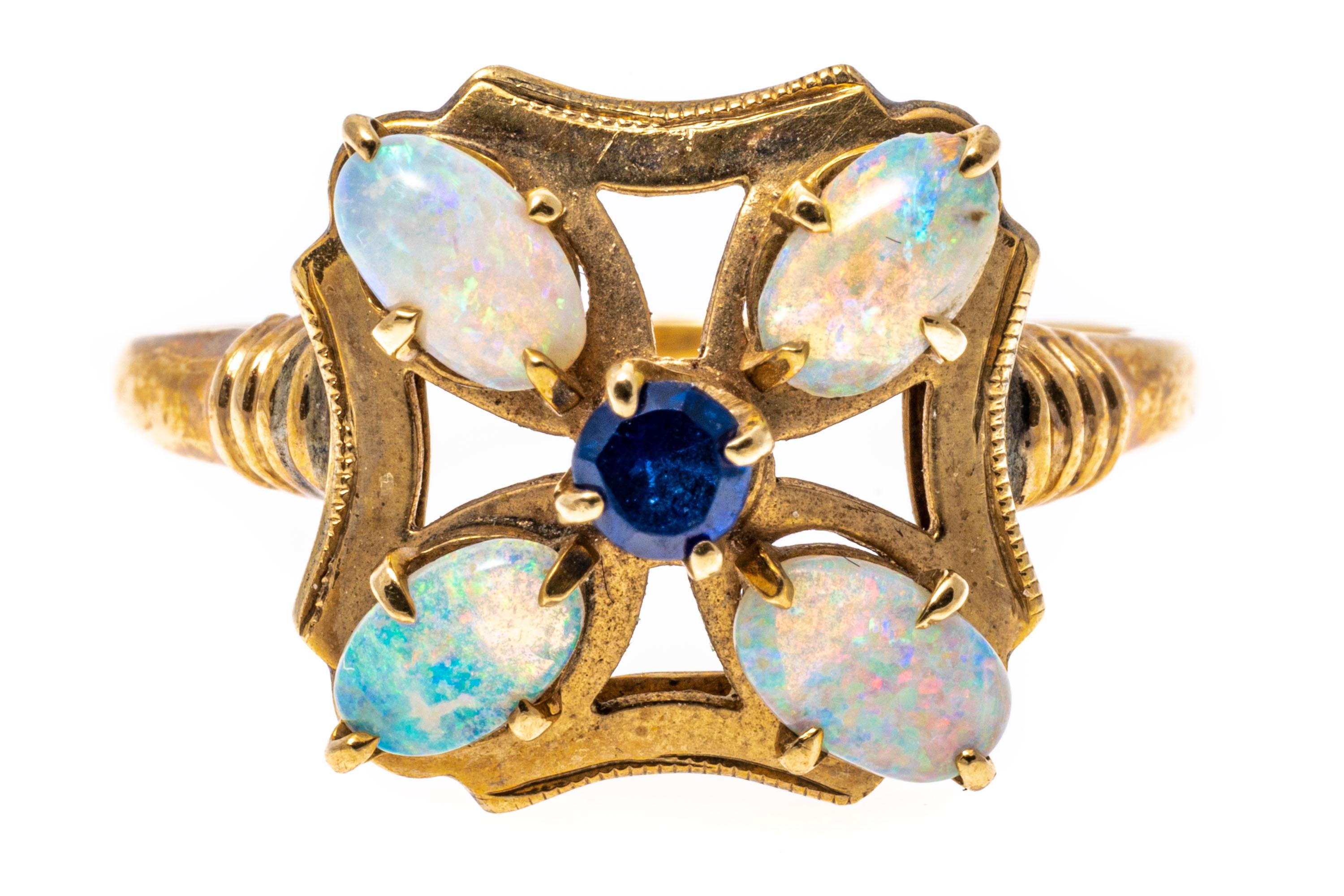 10k yellow gold ring. This charming ring is a flower form, set with four oval cabachon cut white opals, approximately 0.32 TCW, which center a round faceted, medium blue color sapphire, approximately 0.14 CTS. All of the stones are prong set.
Marks: