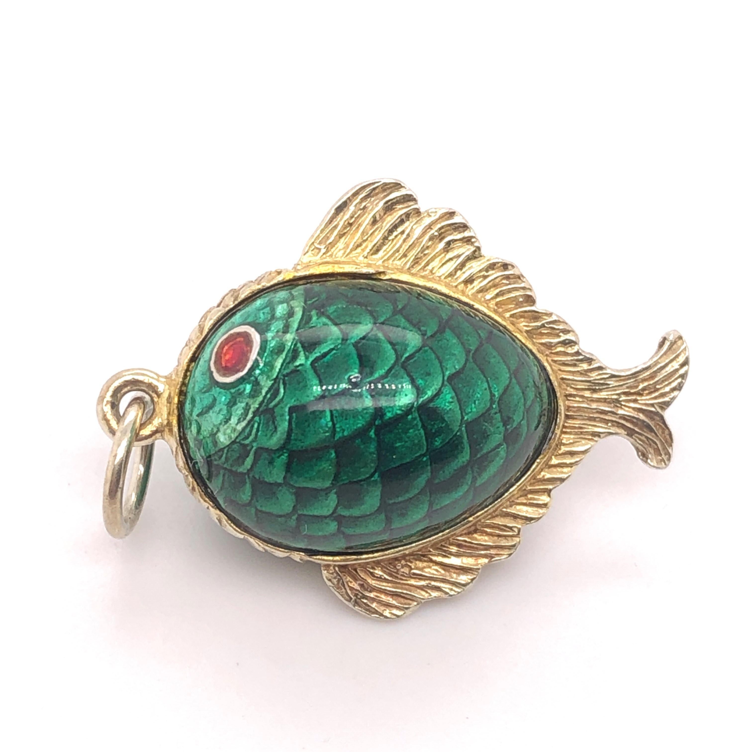 10Kt yellow gold Double Sided Green Enamel Fish Pendant. 

This is a 3-diemnsional charm from the 1960's.

The fish measures 1 inch long with out the jump ring bail. The width is about 13/16 of an inch. 