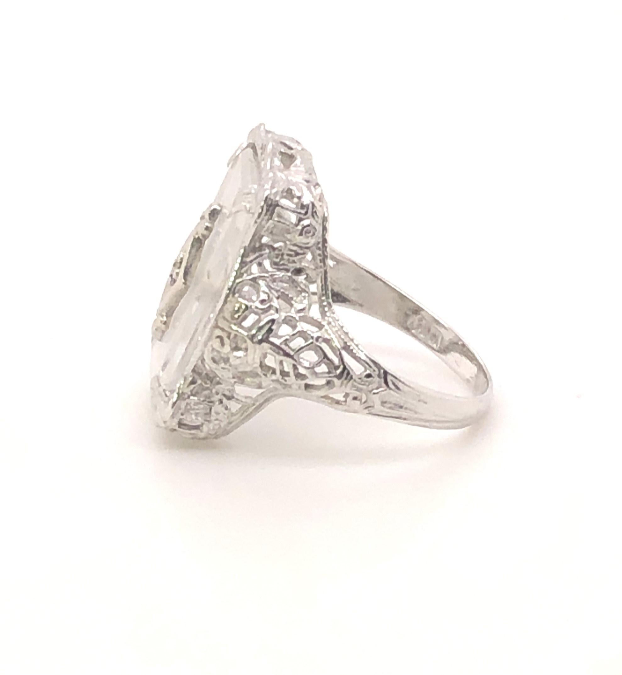 Highly desirable Art Deco camphor glass ring. Camphor glass is always sought after and mostly seen in pins and pendants. Ring are rare to find. This ring is in great shape with no damage to the filigree/open work. 

The ring measures .75 inches long