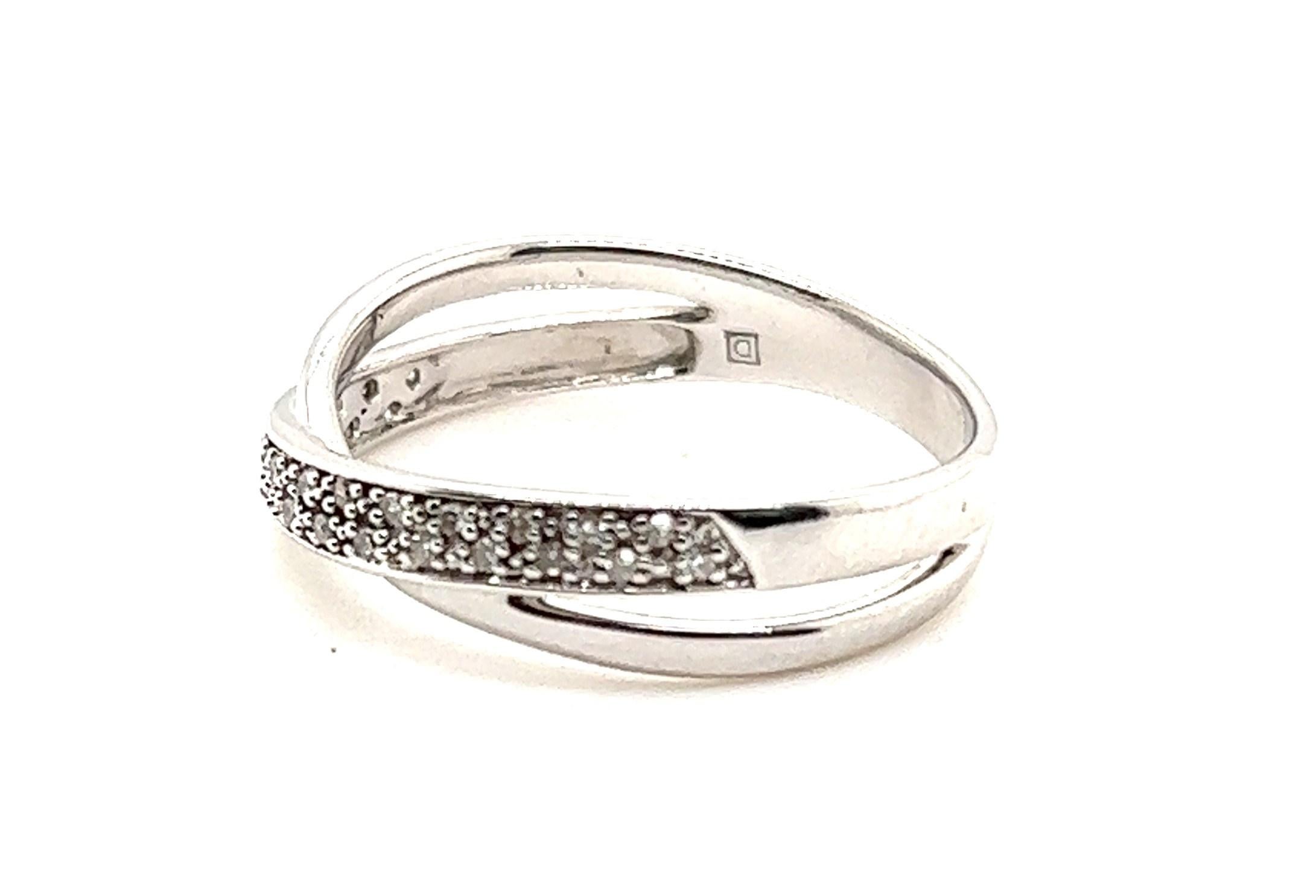 10kt white gold crossover style ring. The ring contains one 