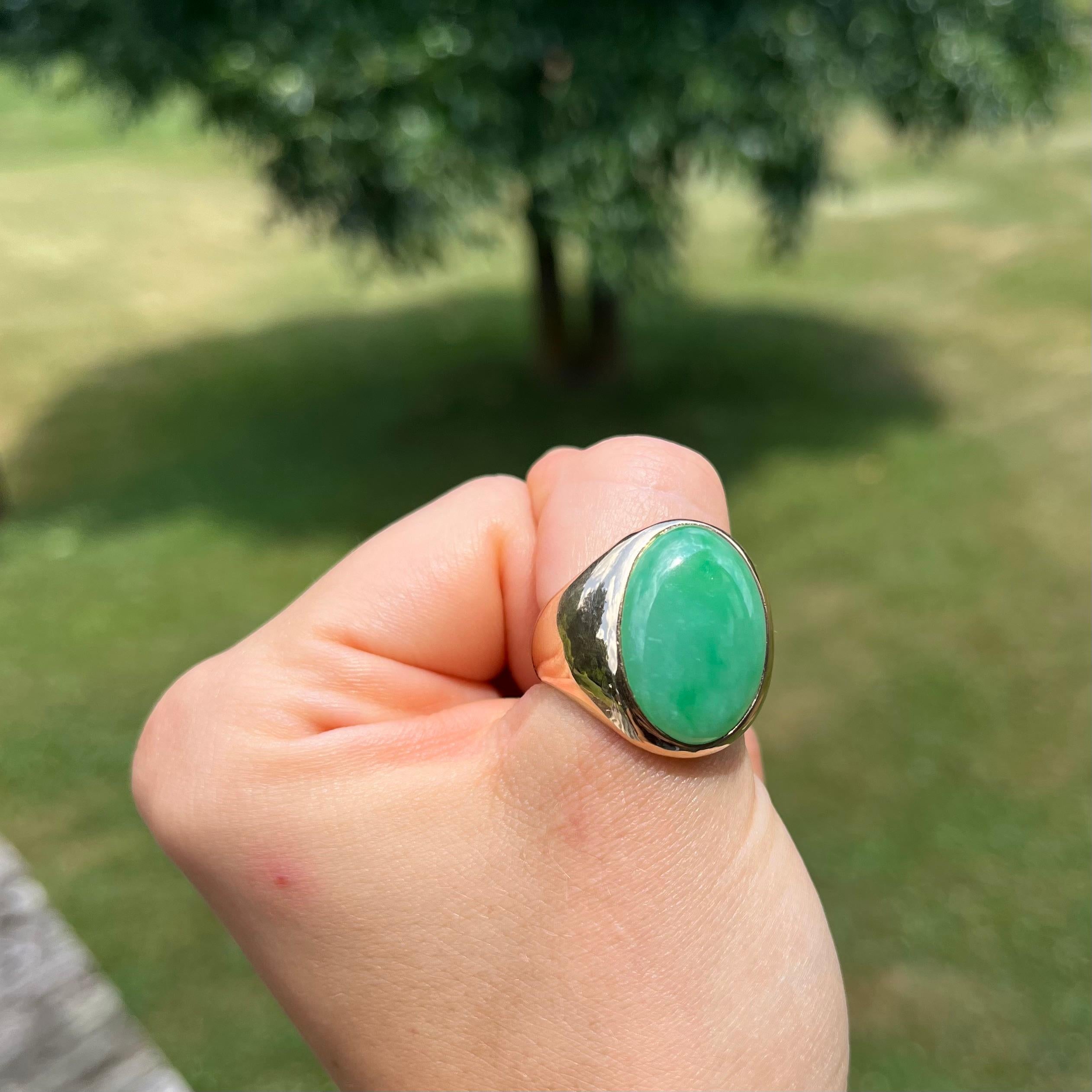 This ring is classic and sleek. It was made in New Jersey c. 1949 by Church & Co. Jewelry. It is set in solid, 10-karat gold and features one piece of Jadeite Jade measuring 14 carats. The ring has a low profile and is a size 10. The shank measures