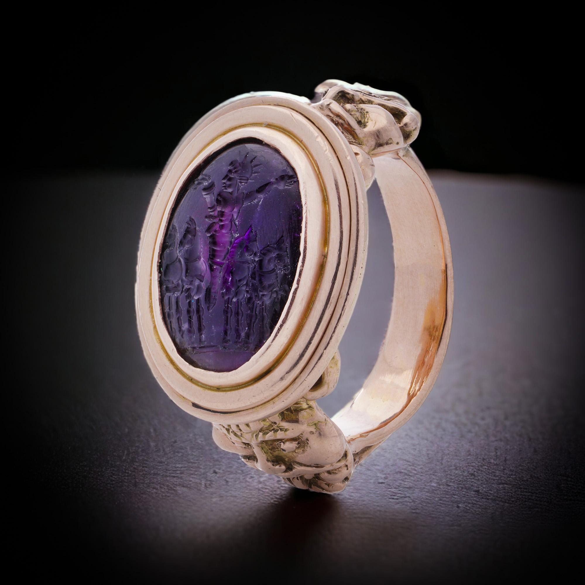 Antique 19th-century 10kt. pink gold men's large-sized intaglio ring with a carved amethyst, featuring the God Helios. The shoulders of the ring's shank are nicely decorated with two different face masks.
Made in Europe, Circa 1890's 
X-Ray has been