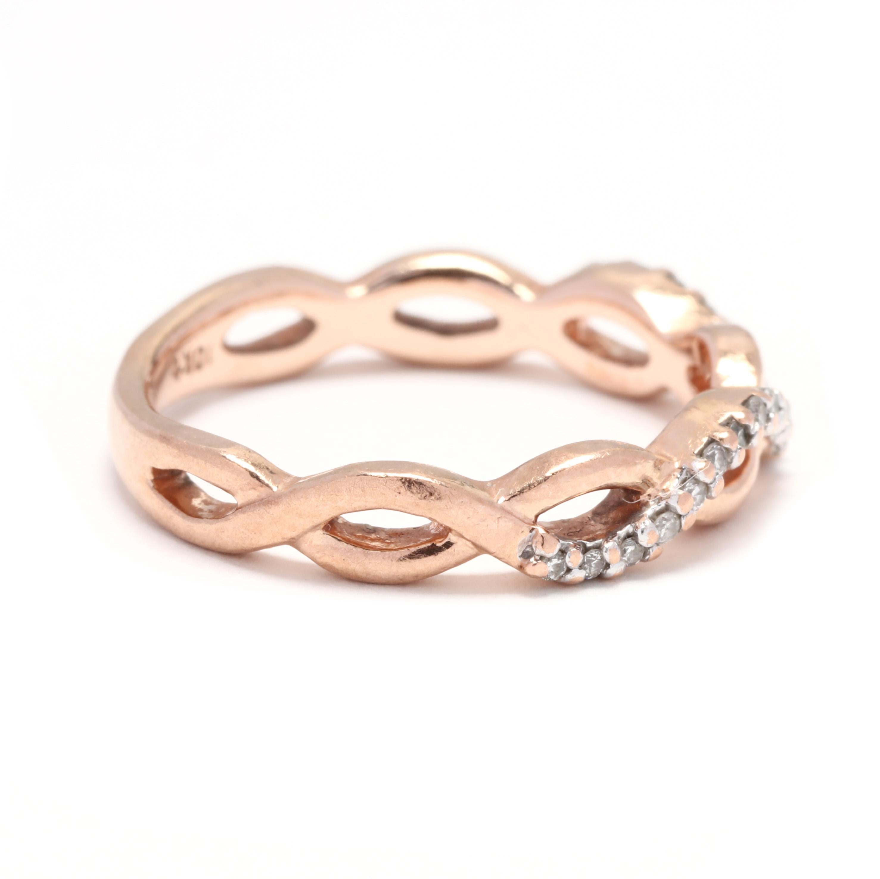 A 10 karat rose gold and diamond criss cross infinity band ring. This ring features a criss cross design that creates an infinity motif with one polished band and another with pavé set diamonds weighing approximately .10 total carats.

Stones:
-