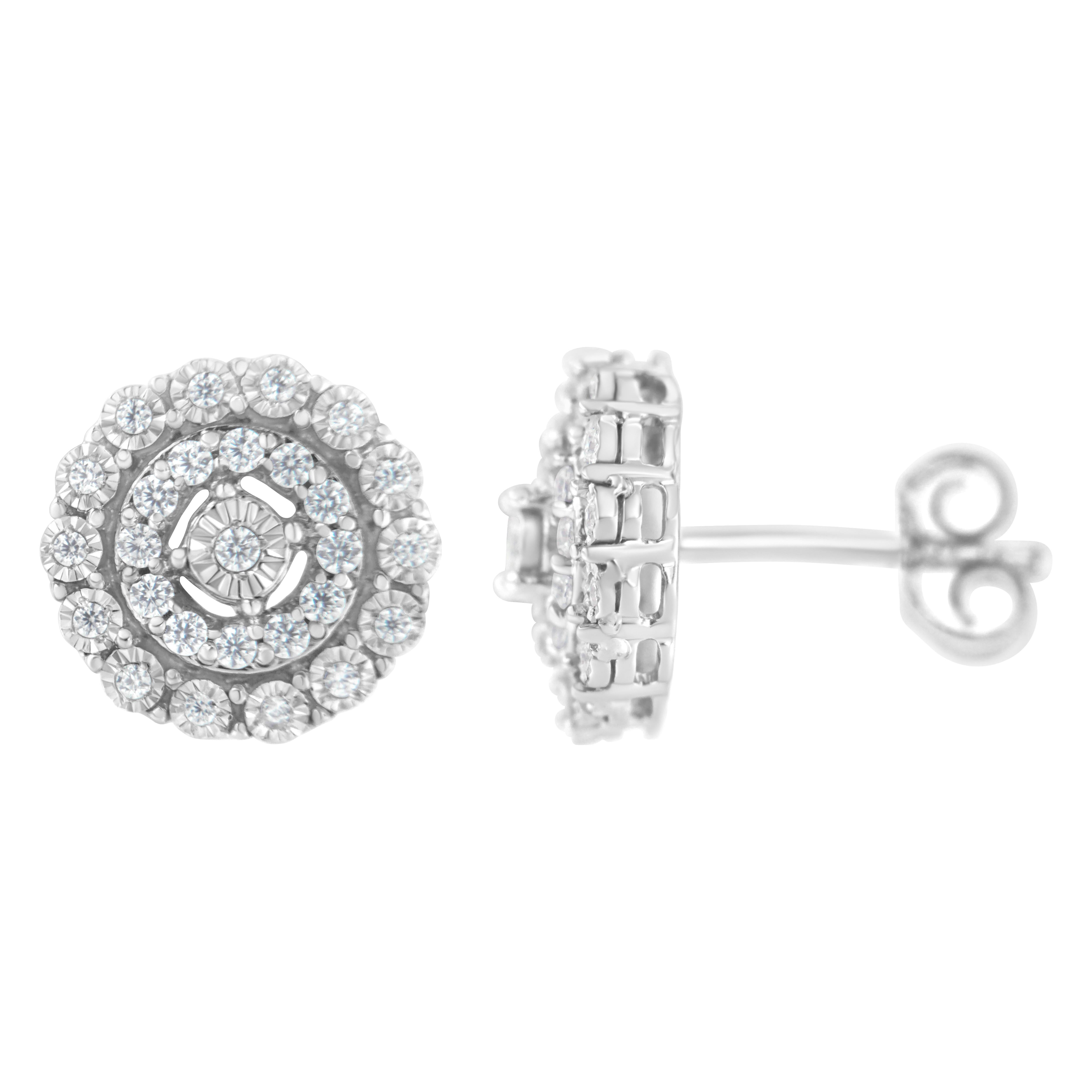 These striking stud earrings are crafted in polished 10k white gold and feature 1/2ct TDW of diamonds. A round cut diamond sits at the center of the design. A double floating halo studded with additional sparkling round diamonds wraps around the