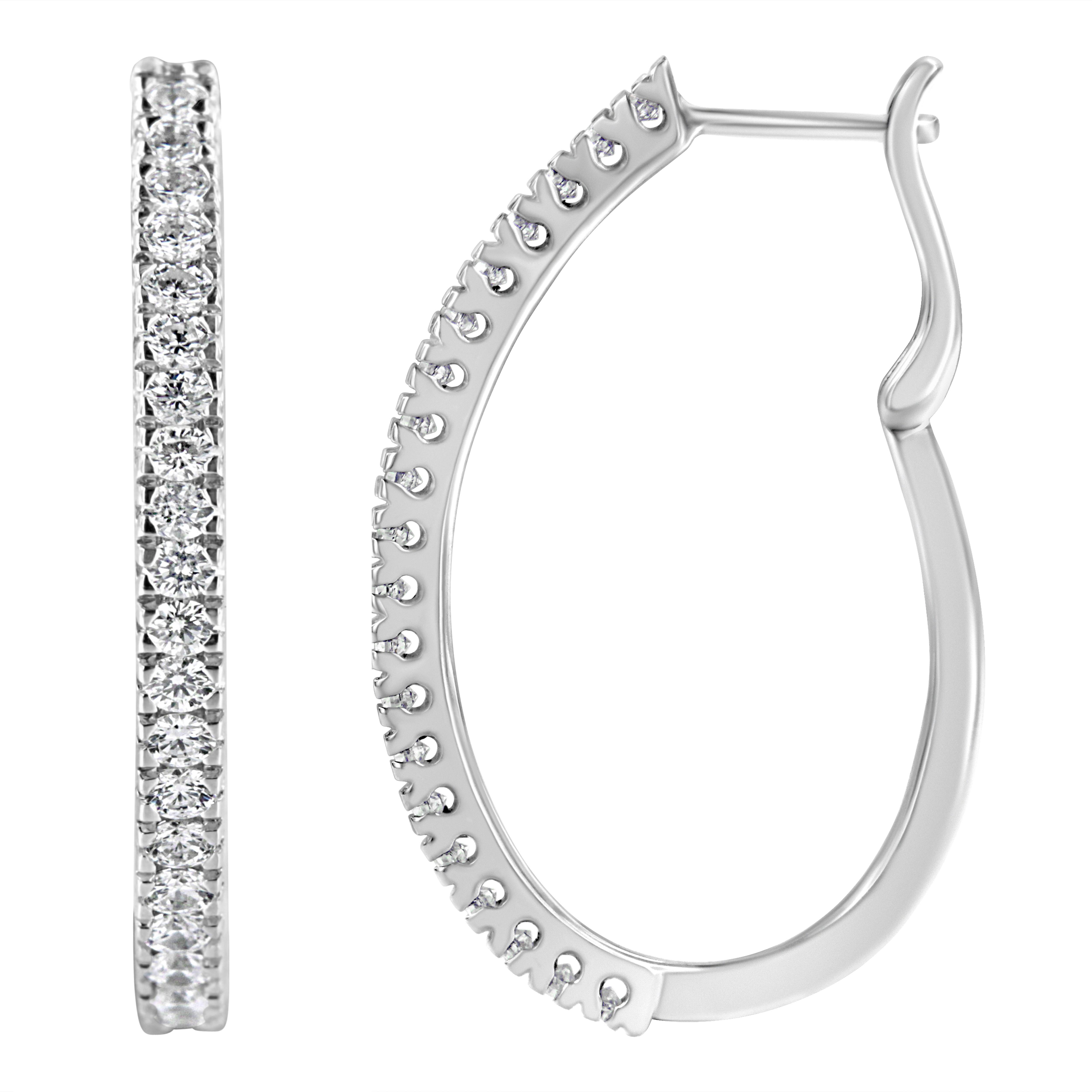 This classic 10k white gold hoop earring feature 1ct TDW of glittering round cut diamonds. The round diamonds are pave set along the front of the hoops for a fine, clean luxury look. A lever back closure keeps the earrings secure.

'Video Available