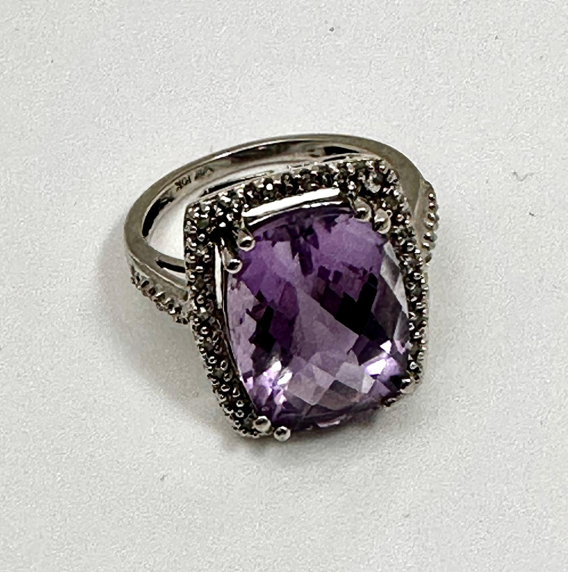 10kt White Gold 11mm x 15mm Cushion Cut Amethyst and Diamond Ring Size 6 3/4
Stone measures approx 11mm x 15mm
Top of ring measures approx 16mm x 18.5

Often viewed as a stone of peace, some believe amethyst's calming presence produces soothing