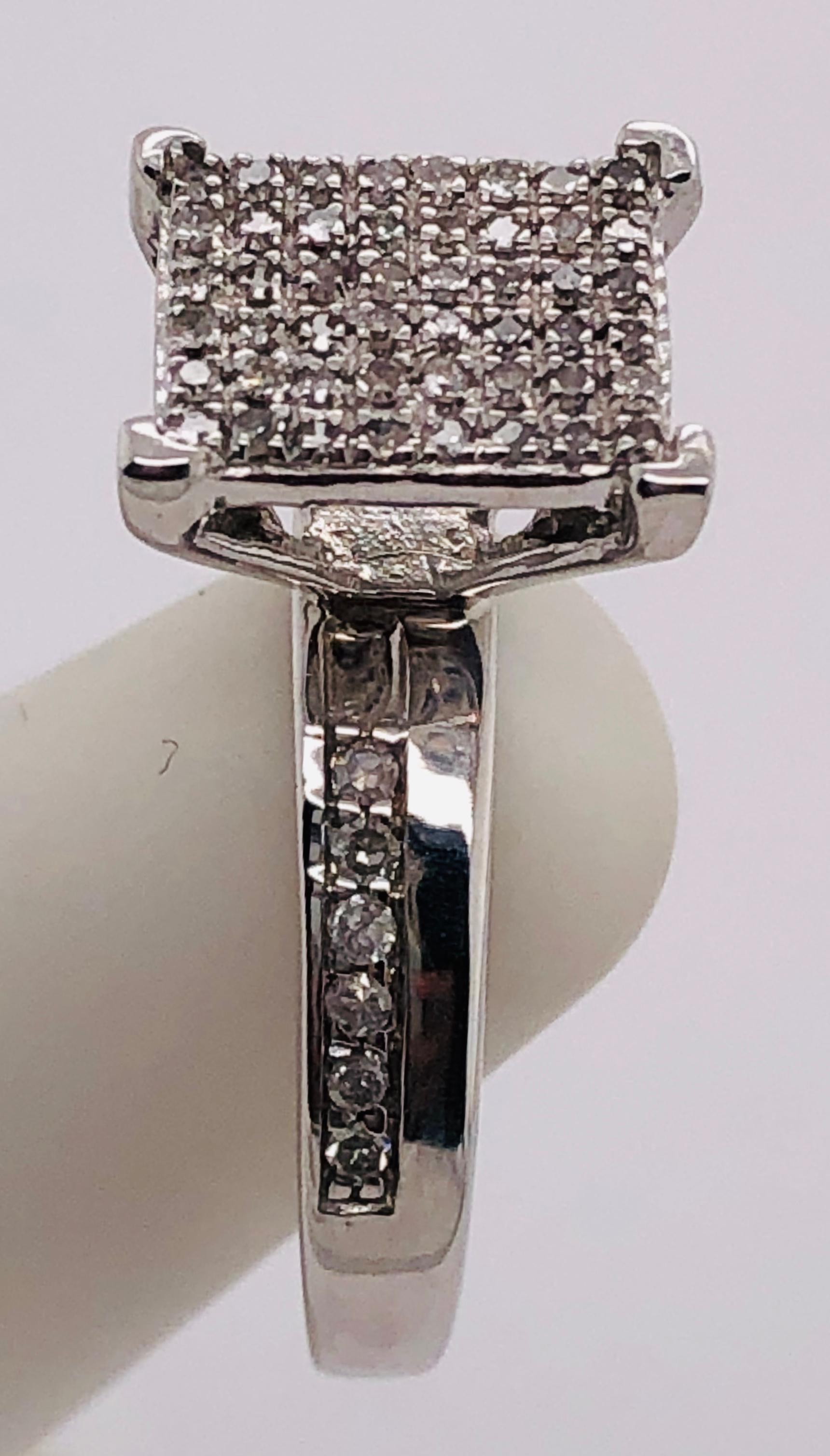 10Kt White Gold Engagement Ring Or Fashion Ring with Diamond Cluster 
1.00 Total Diamond weight
Size 7 
3.51 grams total weight.
