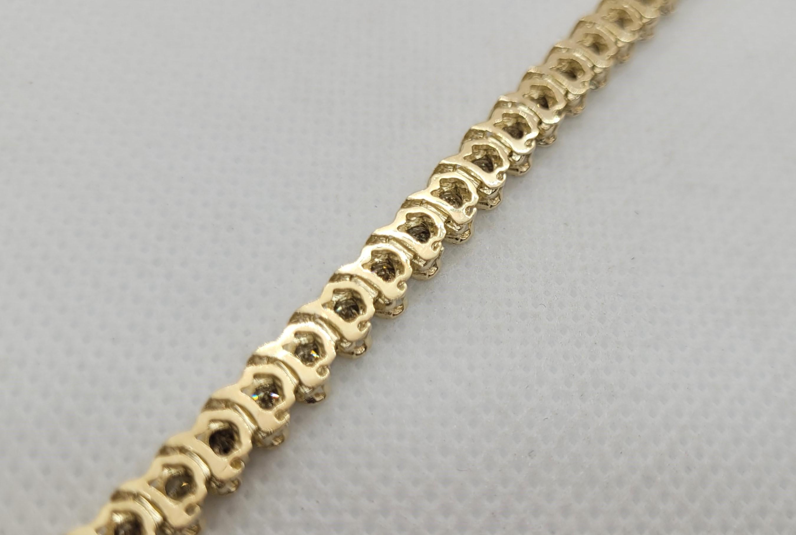 Introducing our stunning 10kt yellow gold S-style tennis bracelet adorned with 50 round brilliant diamonds totaling approximately 4.50cttw! This exquisite piece measures 8.25 inches in length, weighs 12.29 grams, and features a secure push-in clasp