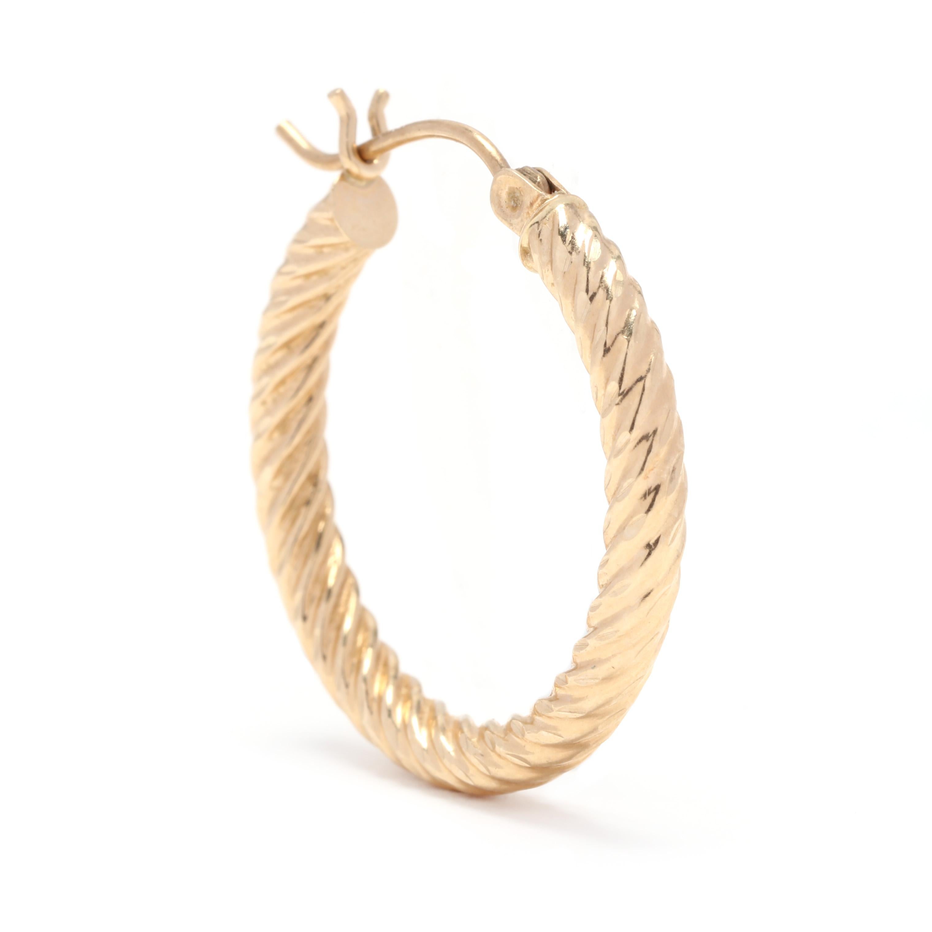 A pair of 10 karat yellow gold twist hoop earrings. These earrings feature a circular, rope twist design with a snap closure.

Length: 7/8 in.

Width: 3 mm

1.1 dwts.

A Couple Of Things to Note:
* This is a vintage item and may show signs of wear.