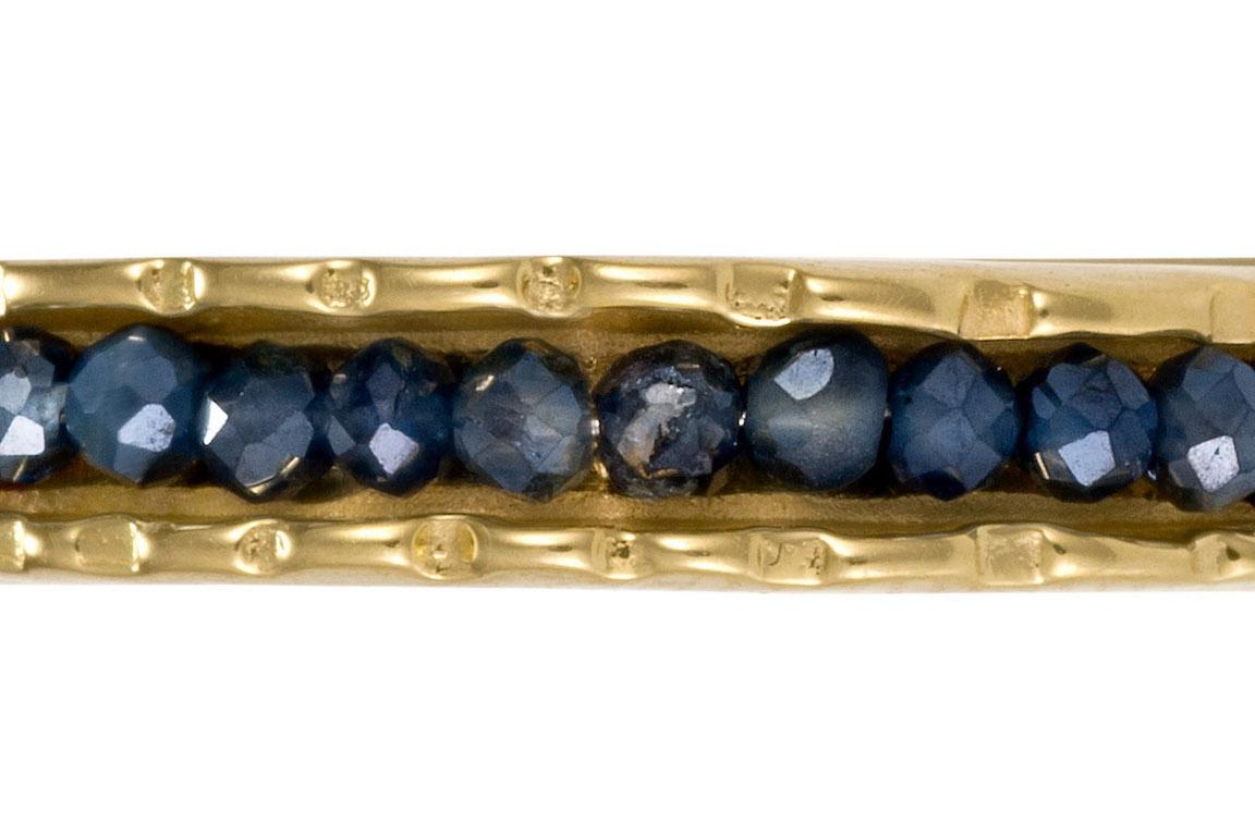 10KY Coin Cuff with Sapphires is part of the Coin Collection.  This collection is inspired by old coins from long ago with their textured worn edges.  Coin Cuffs are limited productions pieces  that come in a variety of colored Diamonds and