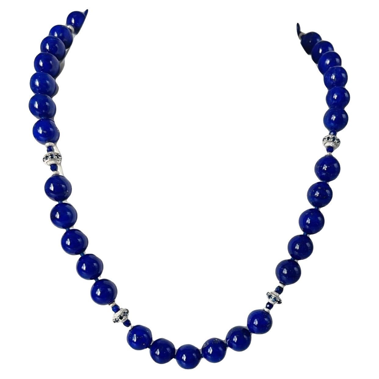 This gorgeous necklace of round lapis lazuli beads with sapphire and white gold accents is the epitome of style and sophistication! 10mm round, beautifully matched lapis with their high-polish and stunning royal blue color have been arranged with