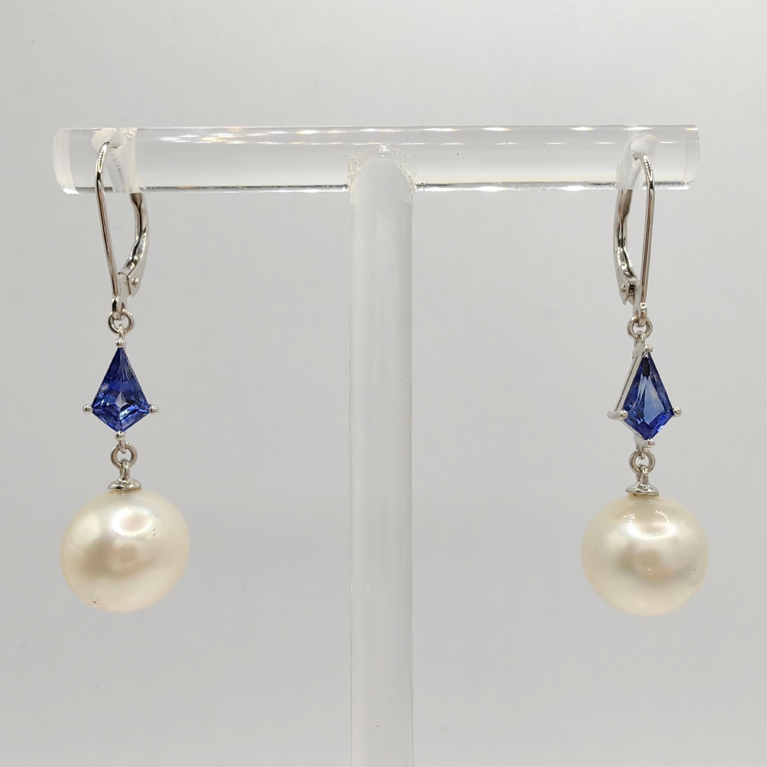 Introducing our exquisite 10mm Natural Pearl & Kite Cut Blue Sapphire 18K White Gold Dangling Earrings, a harmonious blend of nature's finest treasures and impeccable craftsmanship.

At the heart of these earrings are two lustrous Natural White
