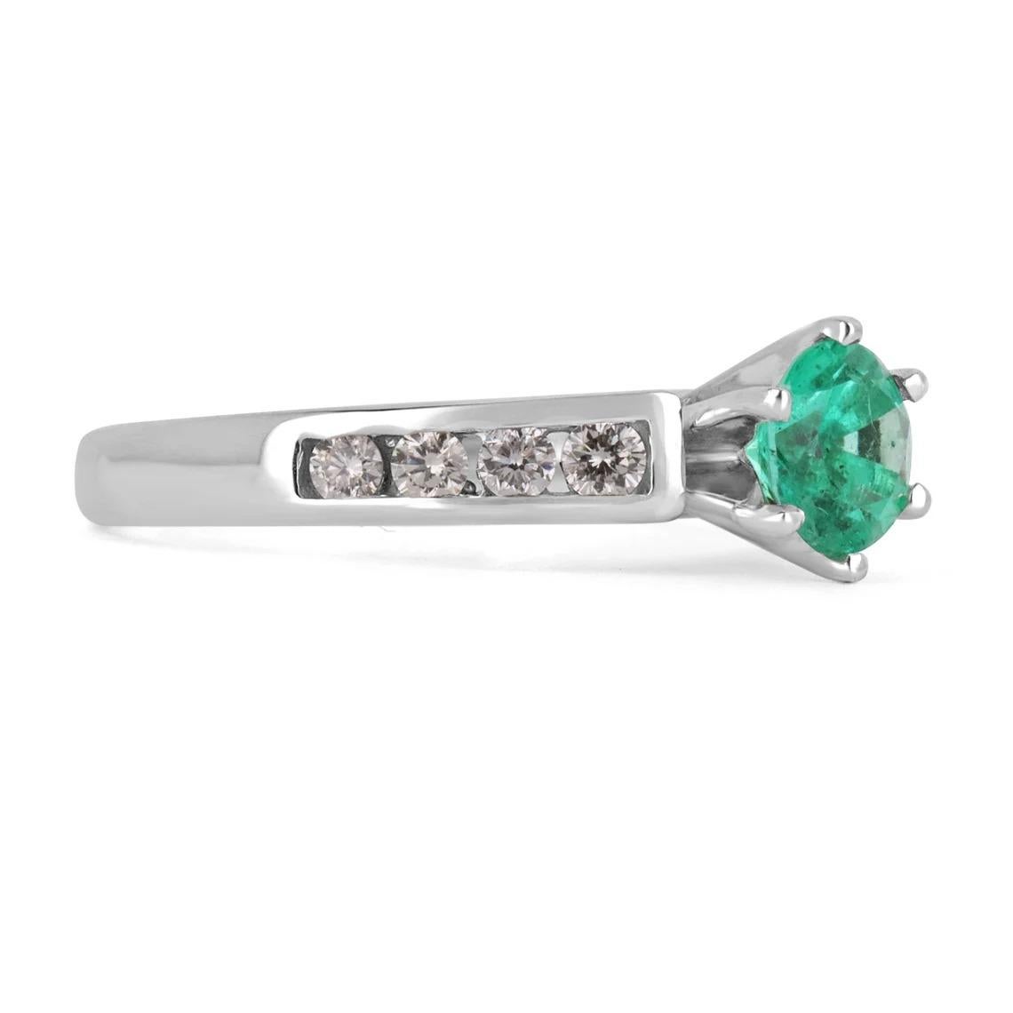 Showcased are a vivacious round genuine emerald and round diamond ring that is sure to set her heart fluttering! Crafted in 14K white gold, this ring features a breathtaking emerald that weighs approximate 0.70-carats and is set in a six-prong