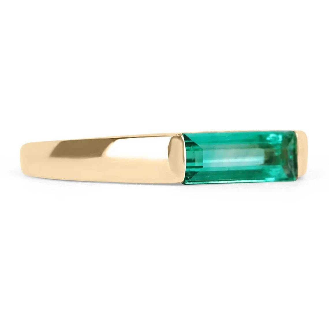Exceptional and unique, this is an 18K Colombian emerald wedding or stacking band. The emerald band features an excellent and minimalist design for full admiration of the stellar baguette-cut emerald. Securely tension-set, perfectly slender emerald