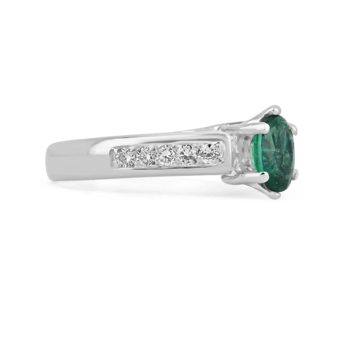 A beautiful emerald and diamond engagement ring. The center stone holds a 0.80-carat oval cut, natural Zambian emerald in a 6-prong setting with a close to excellent eye clarity and excellent-very good luster apart from all its other amazing