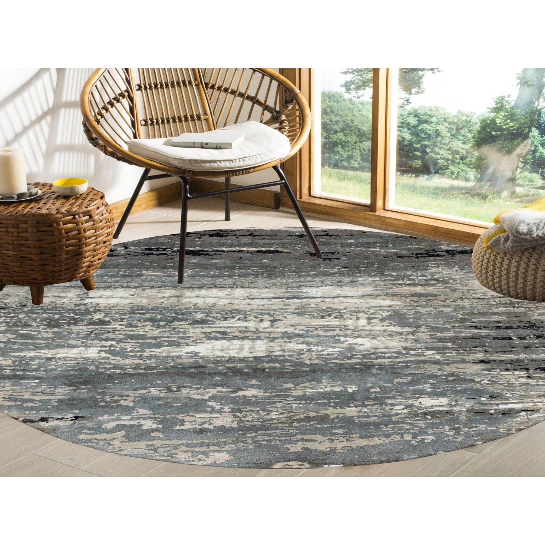This is a truly genuine one-of-a-kind Taupe Hi-Low Pile Abstract Design Wool and Silk Hand Knotted Round Oriental Rug. It has been woven for months and months in the centuries-old Persian weaving craftsmanship techniques by expert artisans.
Primary