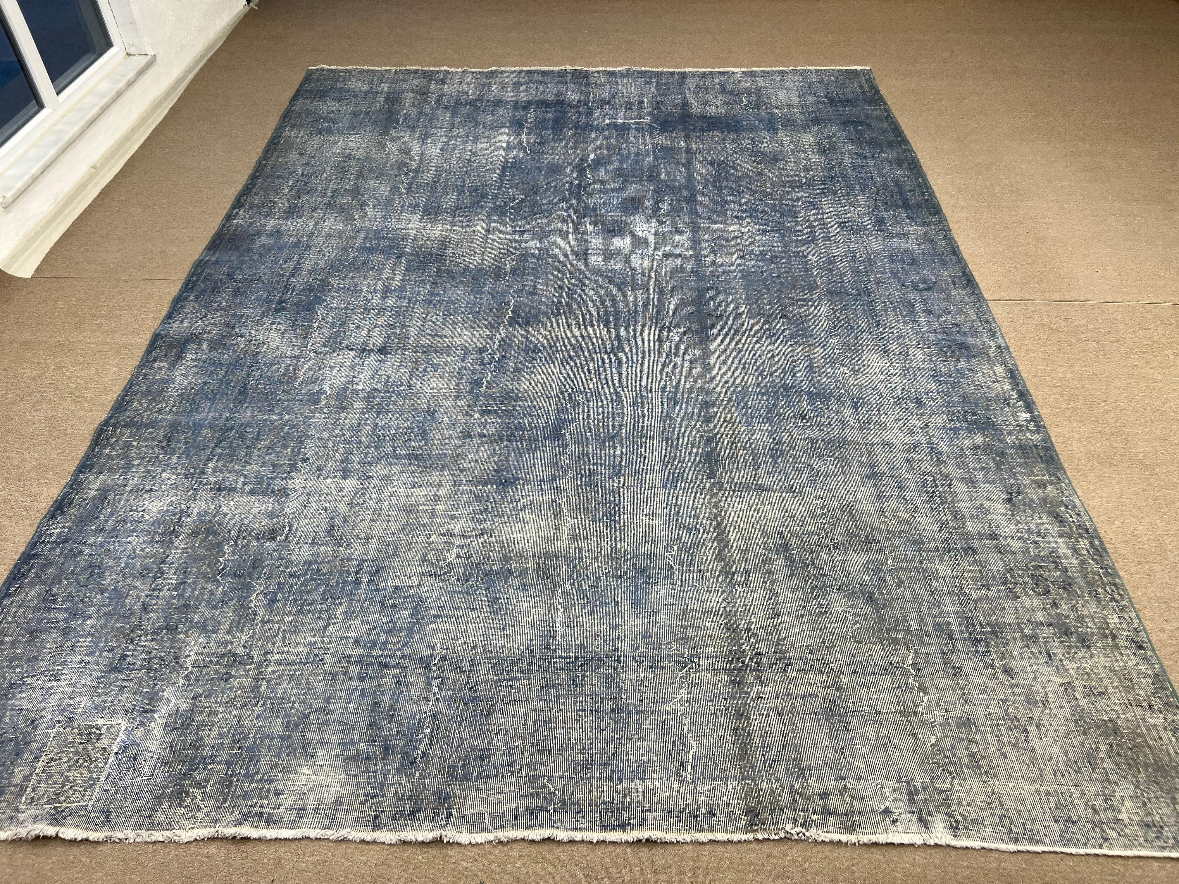 A vintage handmade Turkish rug re-dyed in grayish light blue color.
Finely hand knotted, low wool pile on white cotton foundation. Deep washed.
Sturdy and can be used on a high traffic area, suitable for both residential and commercial interiors.
