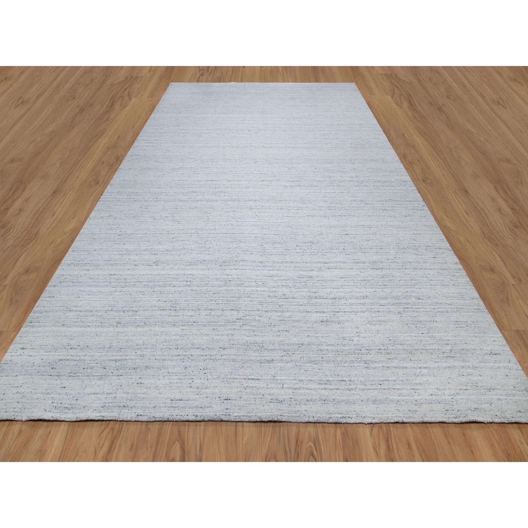 Frost Gray, Thick and Plush, Modern Striae Design, Tone on Tone, Soft Pile, Pure Wool, Hand Loomed, Oriental Rug
Primary materials: Wool
Latex: No Pile 
height: 0.25 Inches
Style: Transitional
Primary color: Grey
Secondary colors: Ivory
Pattern: