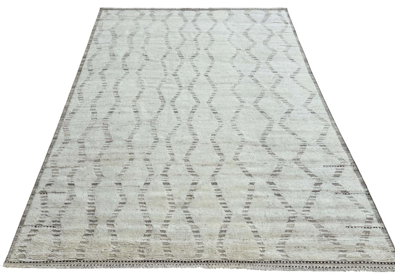 Elevate your living space with the exquisite charm of this new modern hand-knotted Moroccan berber beni ourain rug, crafted with precision and care from 100% wool. Combining the allure of Moroccan design with contemporary sensibilities, this rug is