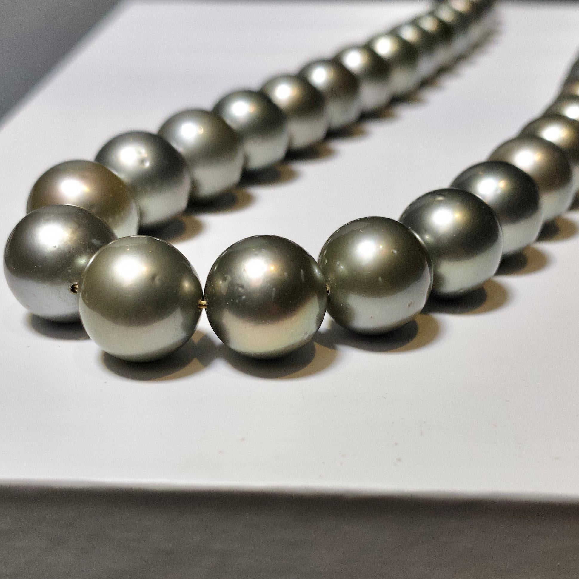 A Strand of Grey colour Silver tone Tahitian pearl necklace with 18K Yellow Gold Clasp. The length of the necklace is 77cm. We can alter the length of this necklace by adding or removing some pearls. please contact us if you want a different length.