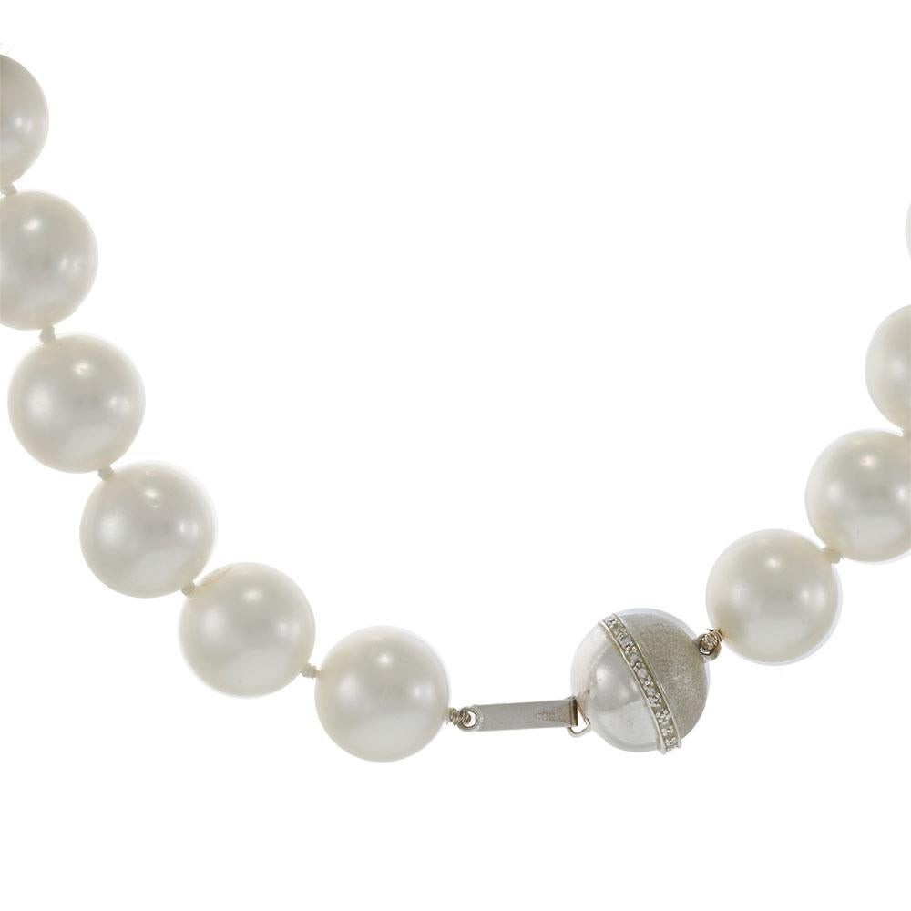 An exquisite strand of white South Sea pearls, graded AAA for their exceptional luster, smooth surface, and round shape. These natural pearls graduate in size from 12MM to an impressive 17MM, showcasing their rarity and beauty. The necklace is