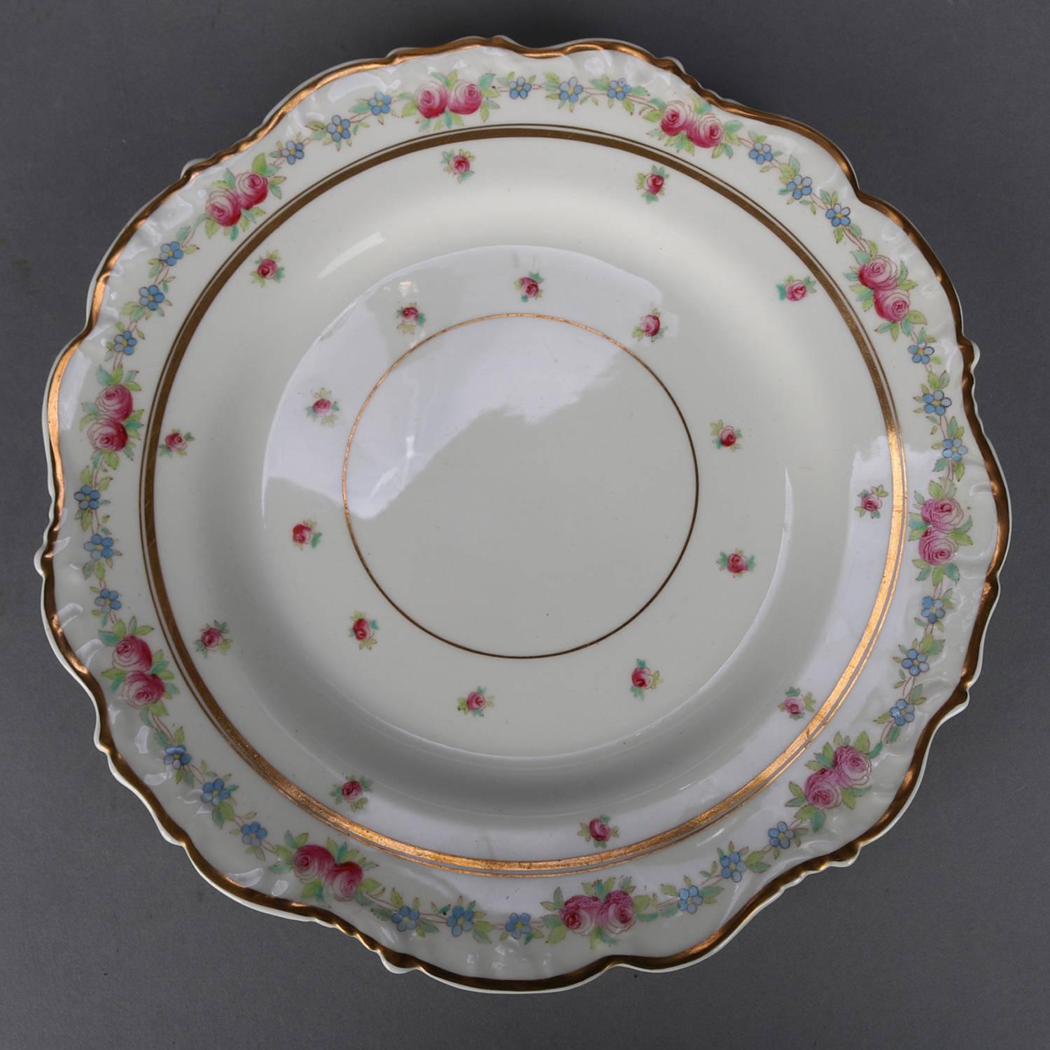 Antique set of 11 English Cauldon porcelain plates feature hand painted floral rim with gilt bordering, en verso 
