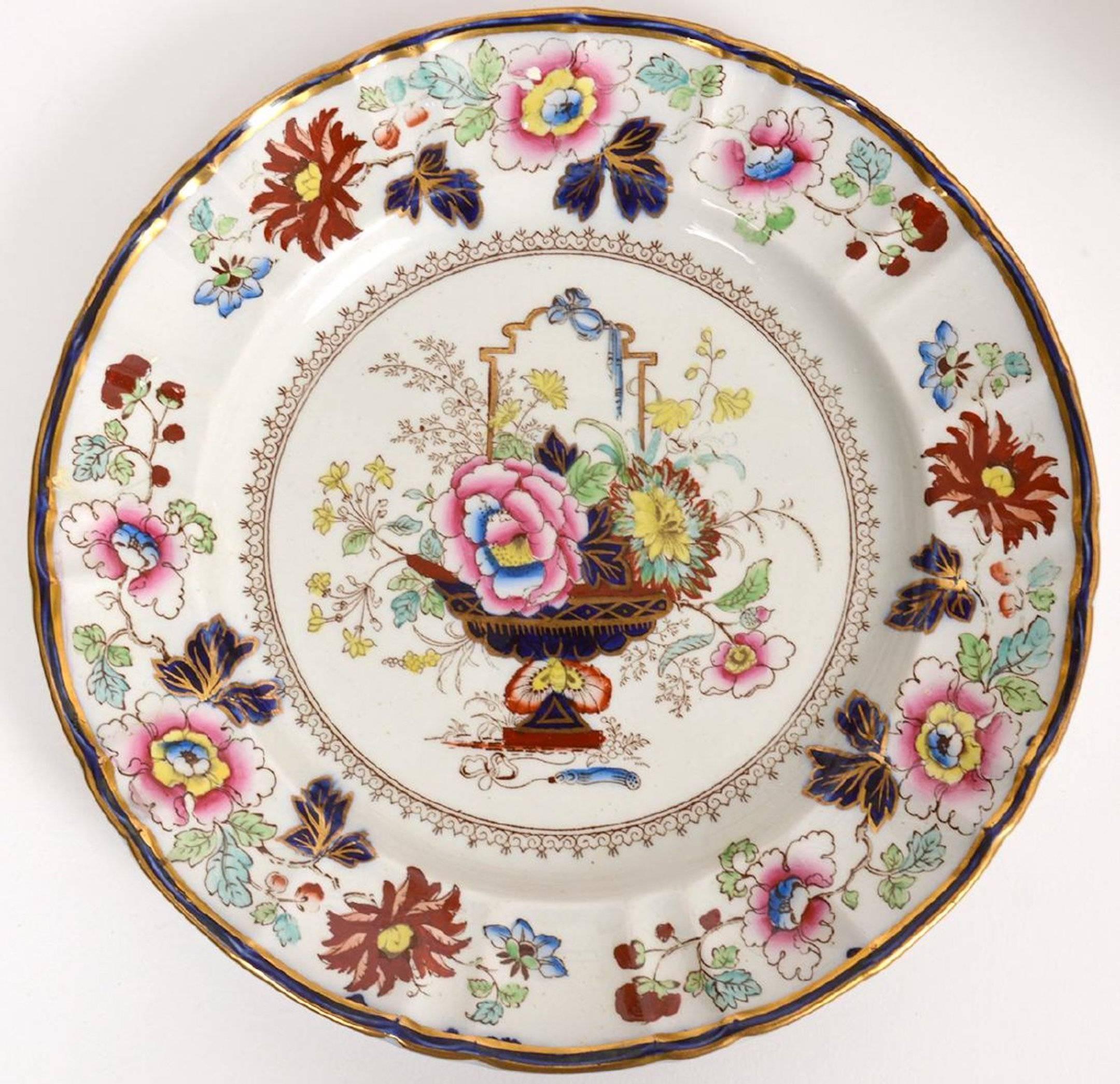 Eleven antique Masons ironstone dinner plates, in the Chinese Taste, each one decorated with a centre floral bouquet.