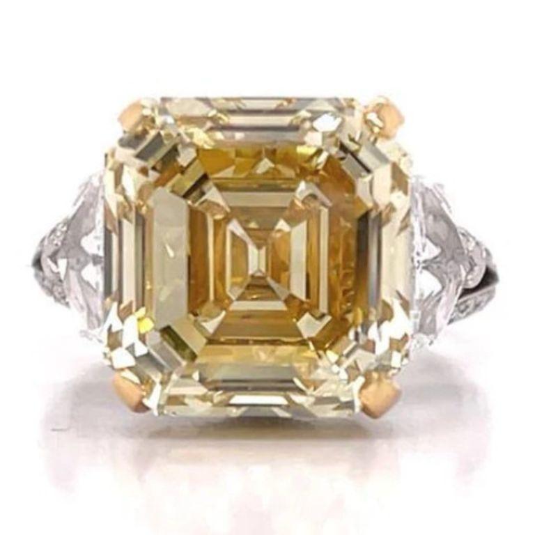 RAYO -ASSCHER CUT NATURAL FANCY YELLOW DIAMOND ENGAGEMENT RING BY MIKE NEKTA
GIA CERTIFIED

Center Diamond:
Carat Weight: 10.2 Carats
Color Grade : FANCY BROWNISH YELLOW
Color Origin : NATURAL
Color Distribution : EVEN
Clarity: VVS2
Style:  ASSCHER