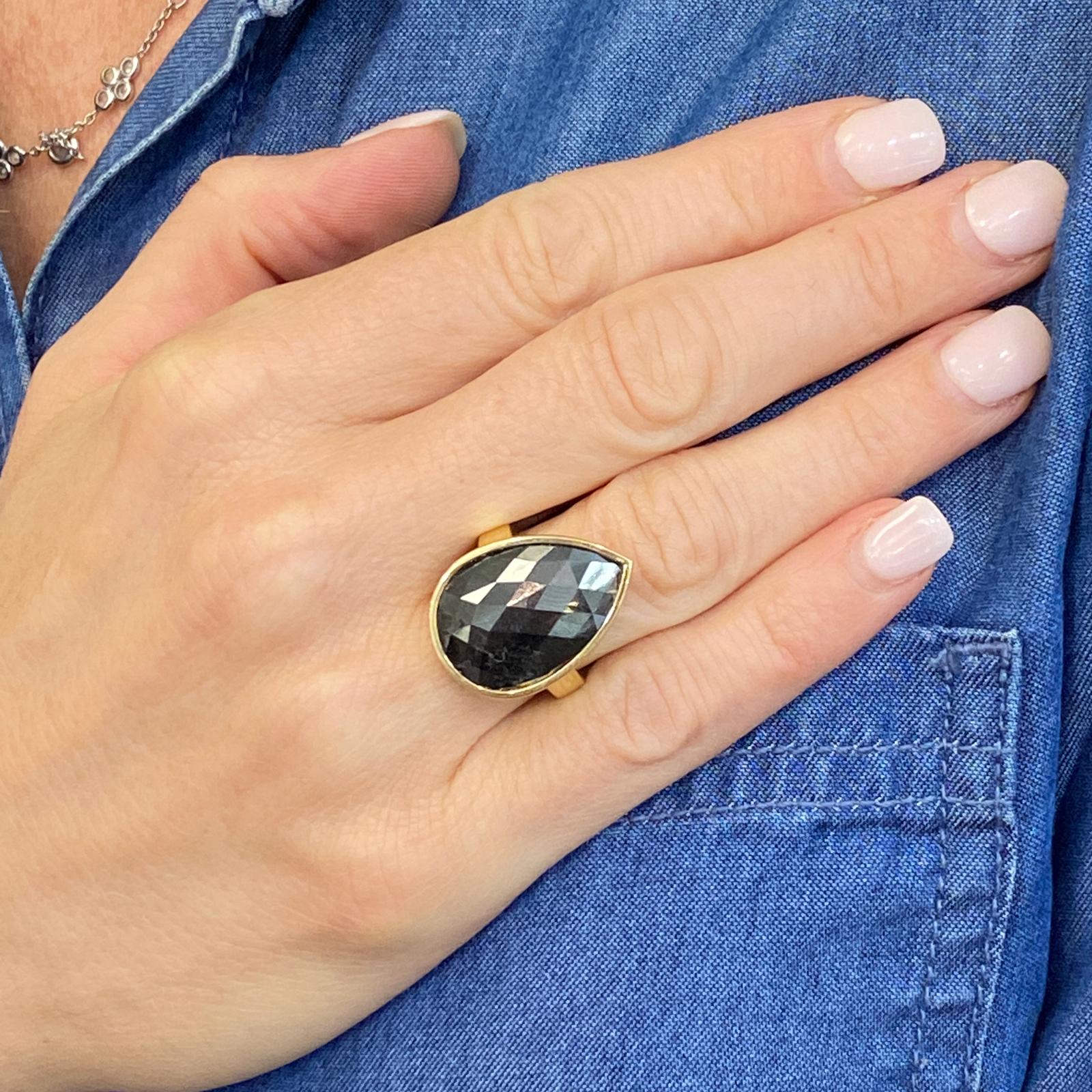 Fabulous and sleek black diamond ring bezel set in 18 karat yellow gold. The ring features an 11.67 carat beautifully faceted pear shape black diamond. The top measures 16.5 x 33mm, and the ring is currently size 6 ( can be sized). 