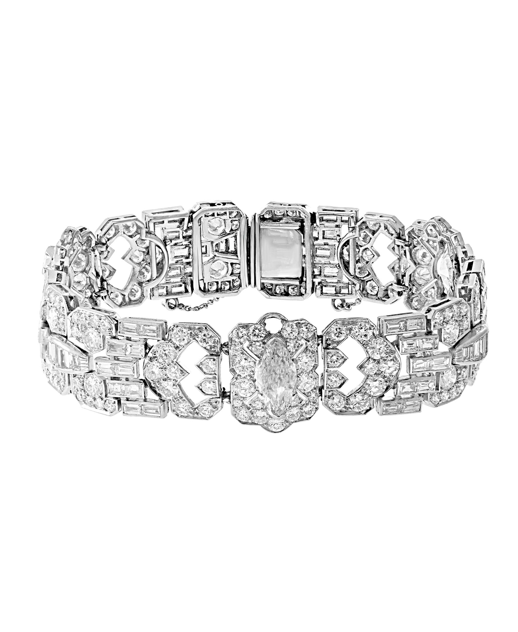 An Art Deco Style Bracelet has a center Marquis shape solitaire diamond 0.92 ct and has two other solitaire diamonds totaling 1.75 carats. 
75 Baguette diamonds total 4 ct
12 round brilliant cut diamonds 1.65 ct
186 round brilliant cut,round