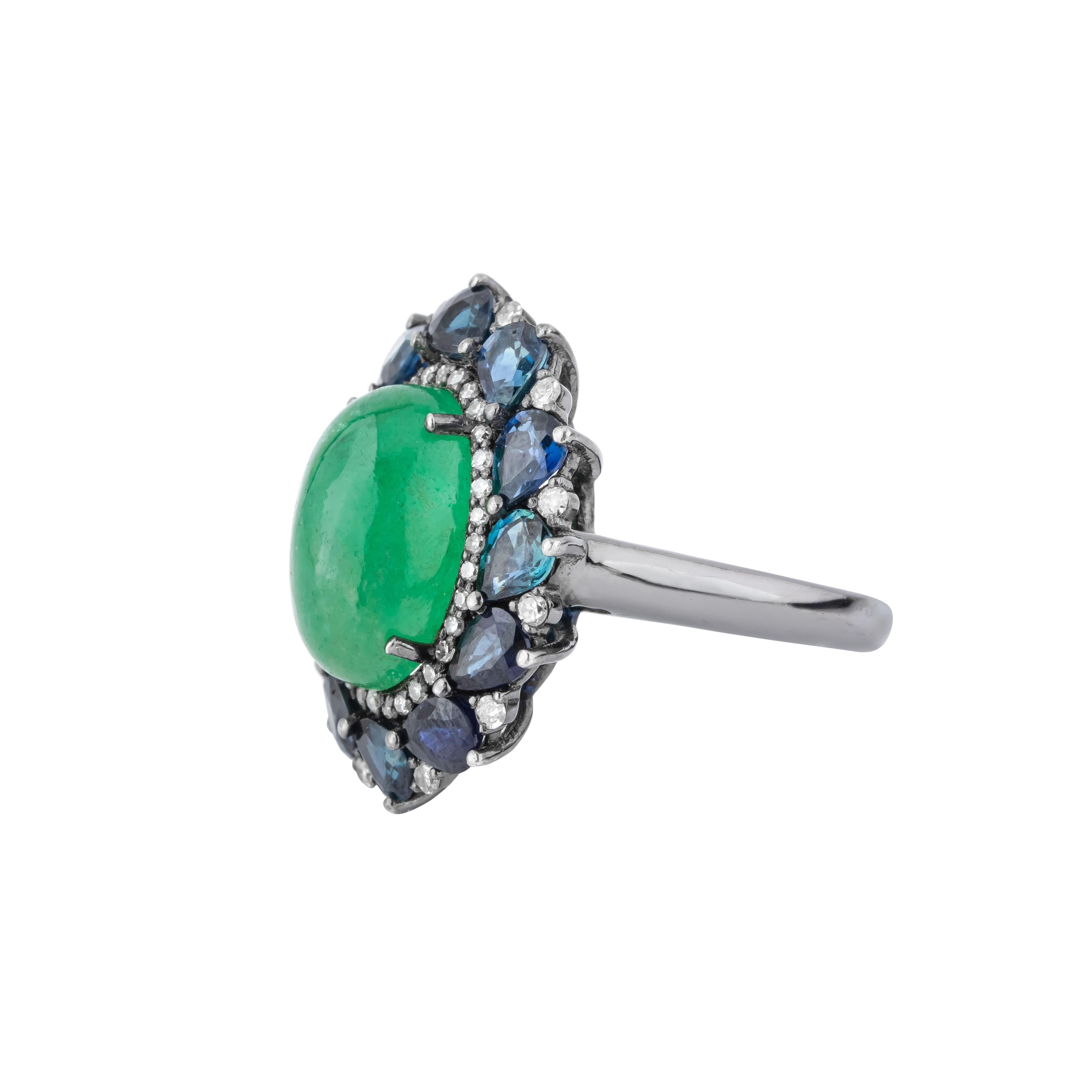 Exquisite in design and unparalleled in craftsmanship, the 11 Carat Diamond, Emerald and Sapphire Cocktail Ring is a masterpiece of opulence. At its core, a stunning color gemstone captures attention with its vibrant hue. This central gemstone,