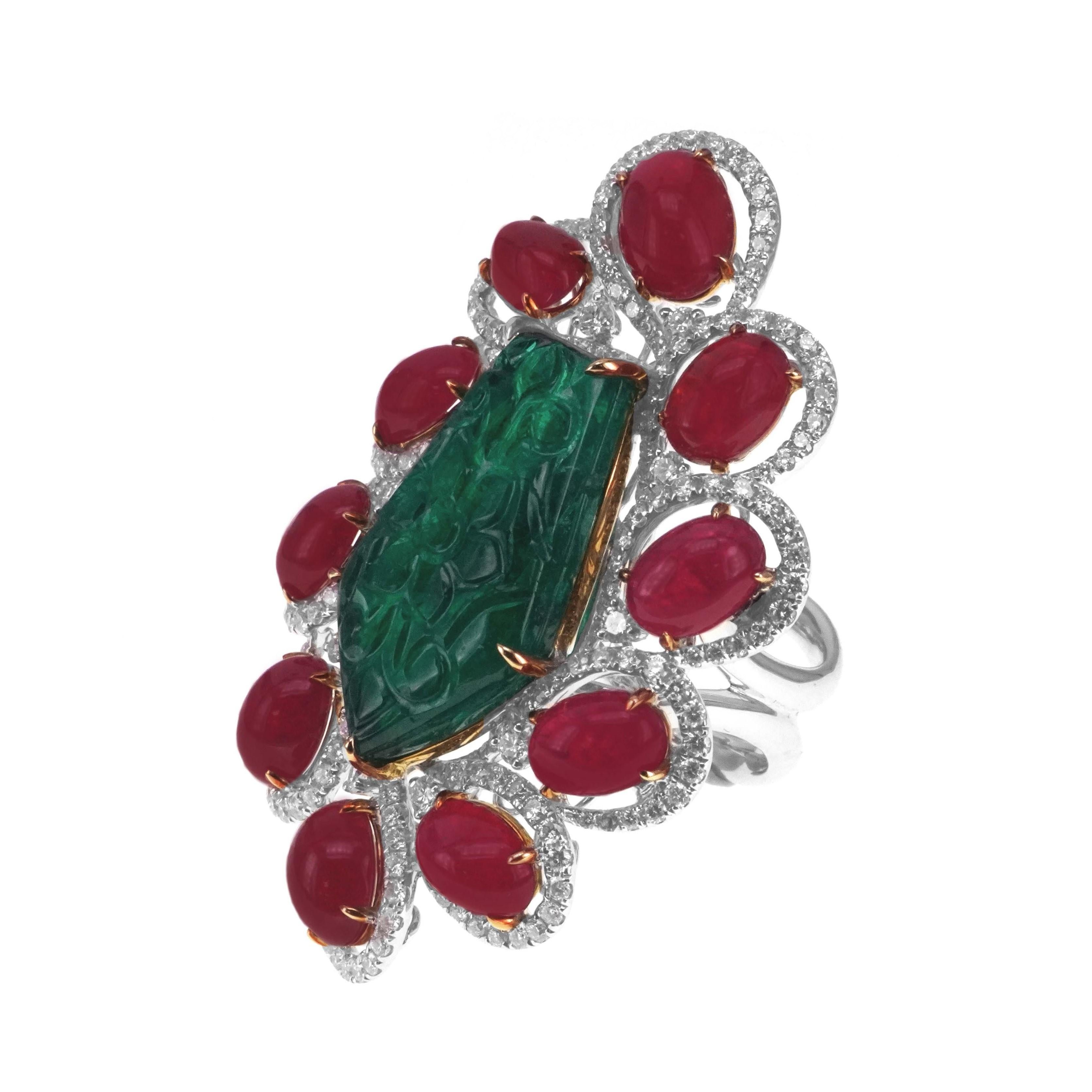 A minutely hand carved old Mughal era vivid green emerald weighing 11 carat is set along with 16 carat of vivid red ruby in this gorgeous looking antique ring. A total of 1.60 carat of white brilliant round diamond are set in this ring. The details