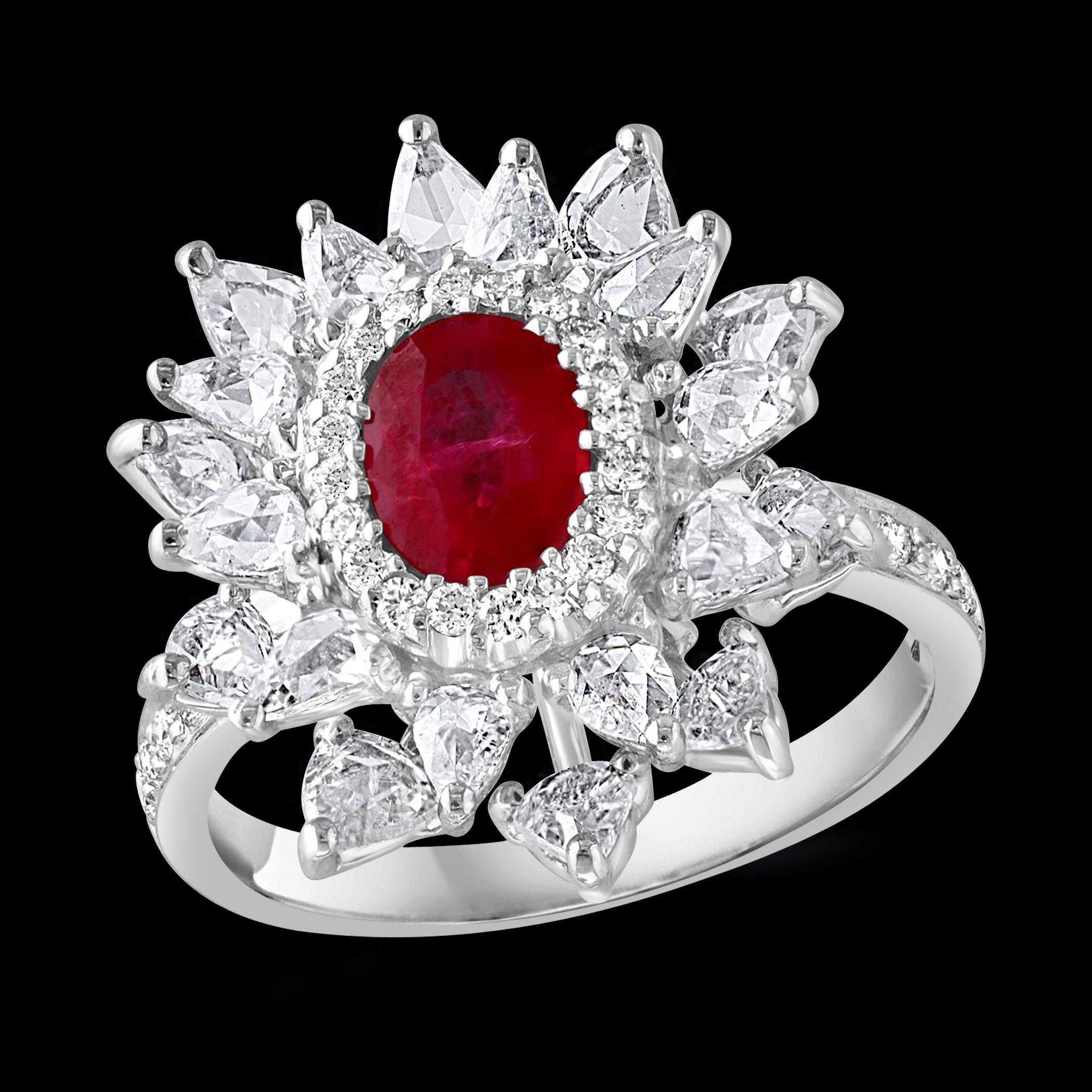 Introducing our exquisite 18 Karat Gold Ring, featuring a stunning 1.1 carat natural oval Ruby and approximately 2 carats of rose cut pear shape diamonds. This ring is a true testament to beauty and elegance. The natural Ruby in this ring is of