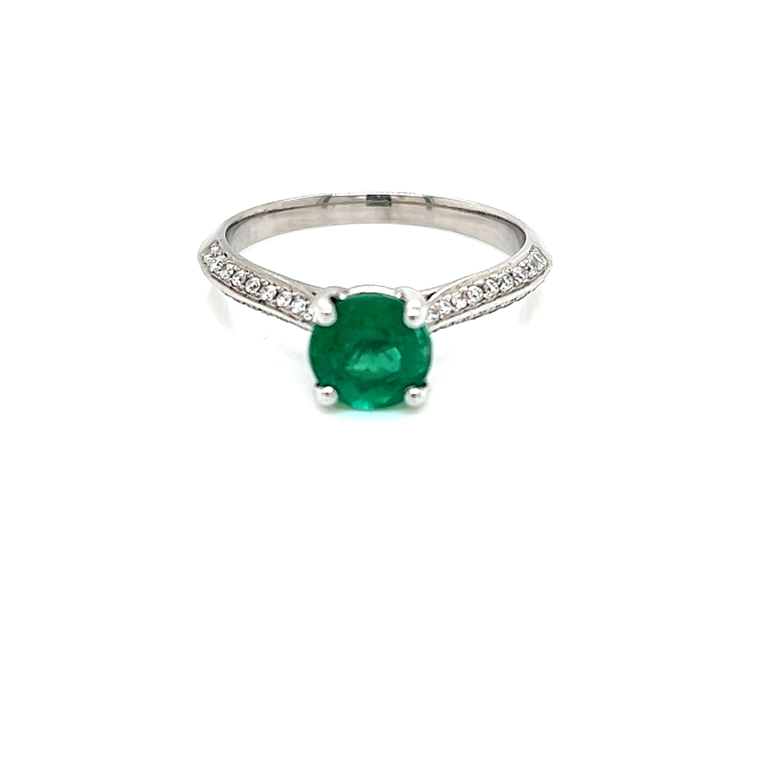 1.1 Carat Round Brilliant Emerald and Diamond Ring in 18 Karat White Gold

This spectacular ring features a gorgeous 1.1 carat Round Brilliant Emerald held in a claw setting on a Diamond encrusted 18K White Gold band. The round brilliant diamonds on