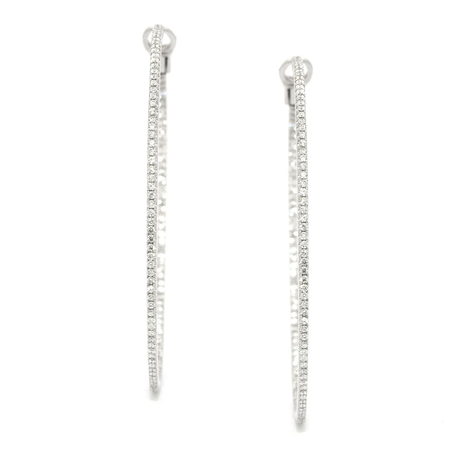 Set with over 450 round white diamonds, a single inner and outer row, with a weight of approximately 11 carats, these earrings are lightweight and full of sparkle. 

Made in 18k white gold

Approximately 6.5cm diameter 


